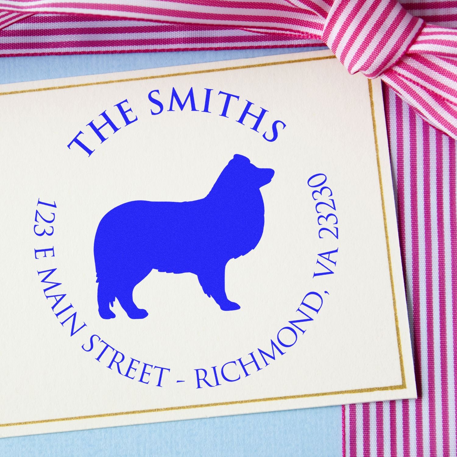 Custom blue dog address stamp and seal with gold border, white card, and pink striped ribbon