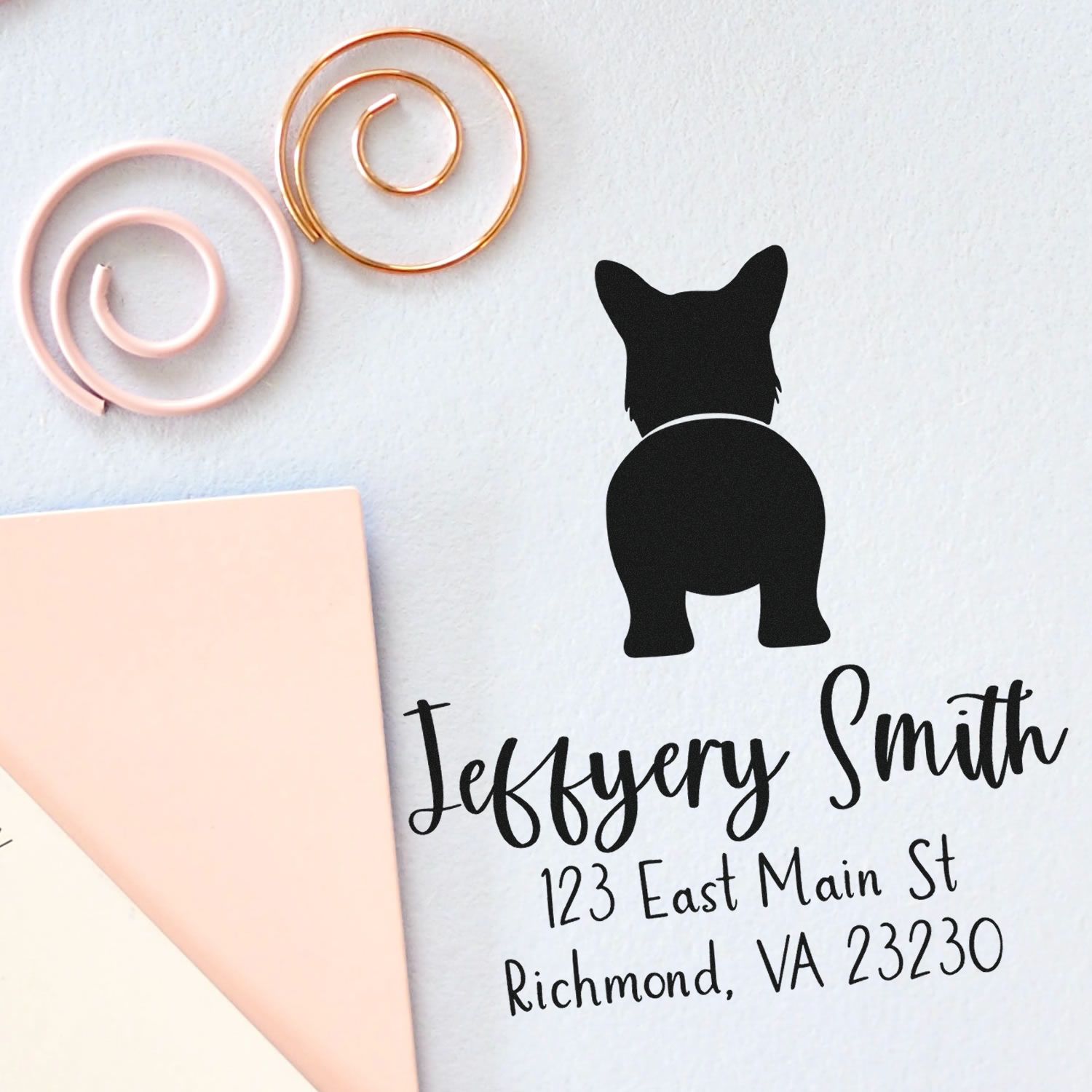 Custom black dog address stamp and seal with Jeffery Smith, pink and gold spiral clips, and blush paper.