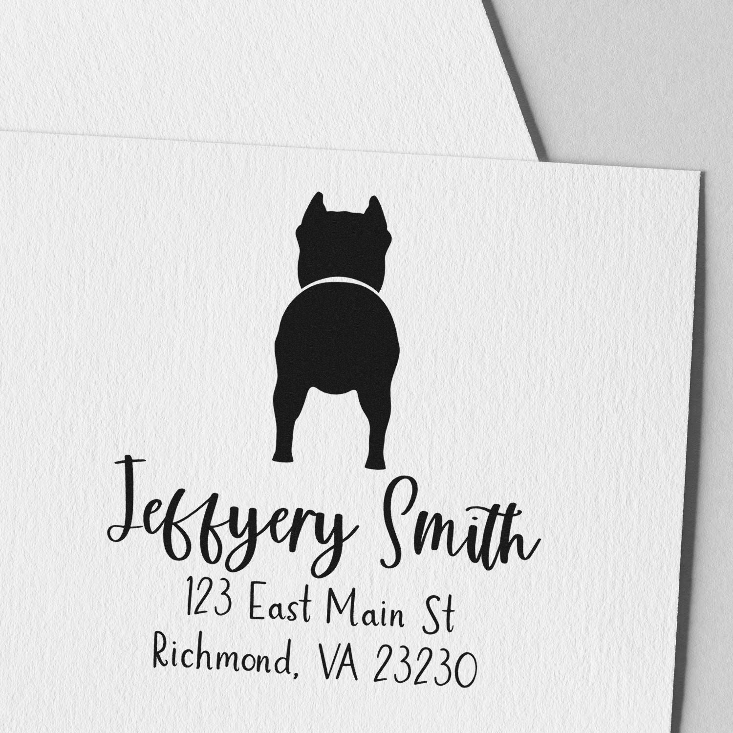 Custom black address stamp with dog seal logo on white textured paper: Jeffery Smith, 123 East Main St, Richmond, VA 23230