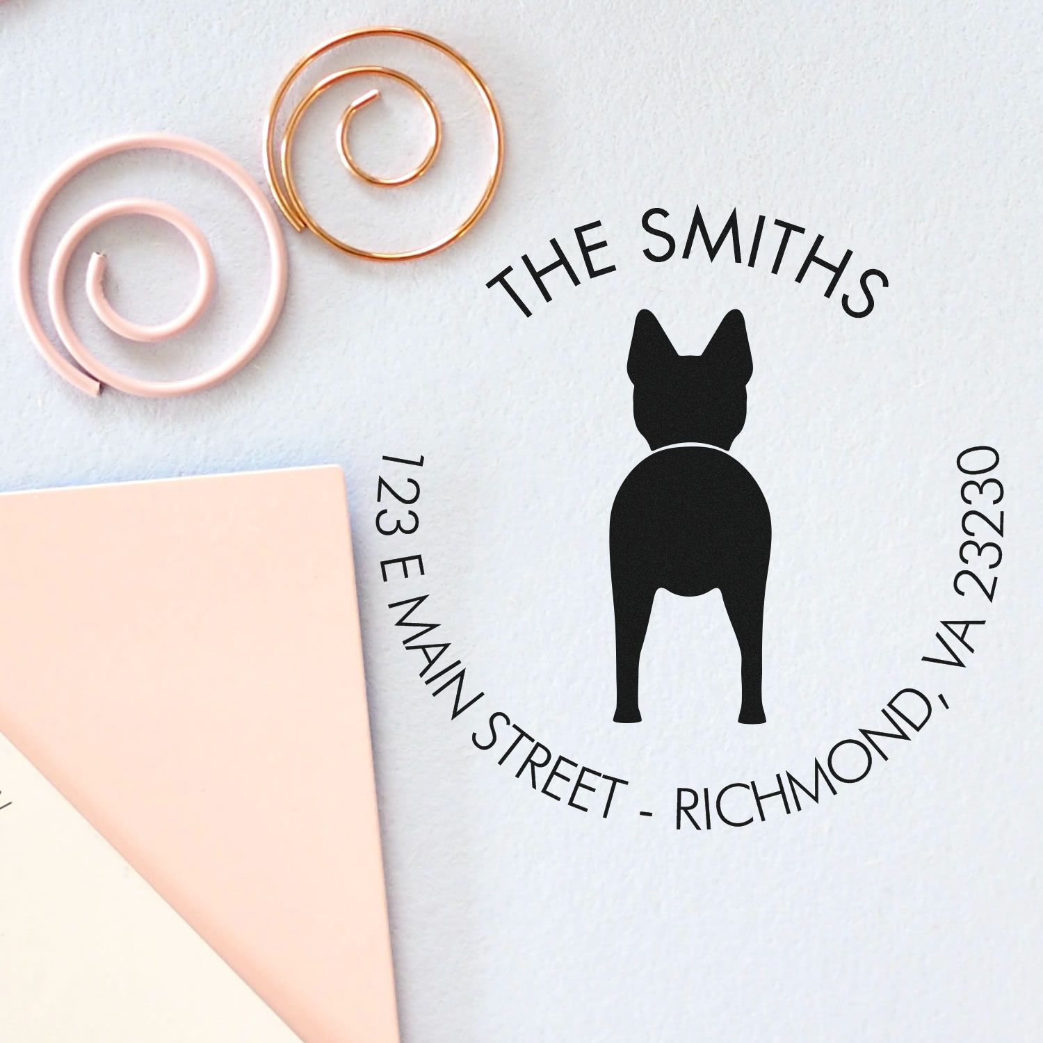 Personalized dog address stamp and seal with black silhouette, pastel pink and gold seal samples on white background.