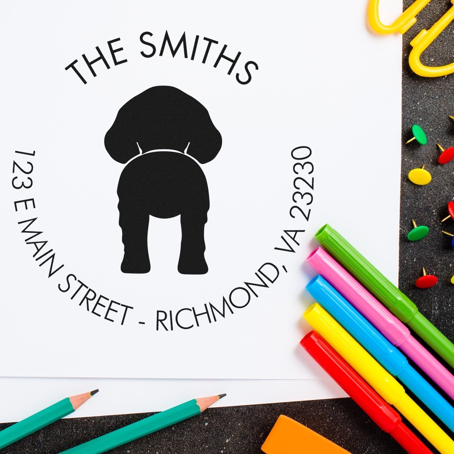 Dog stamp with wood handle by ESS, featuring custom Brittany design for address stamping, shown in use.