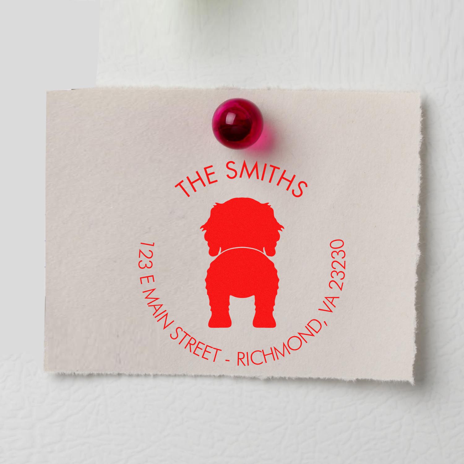Red custom address stamp seal for The Smiths on cream textured paper, pinned with a magenta tack.