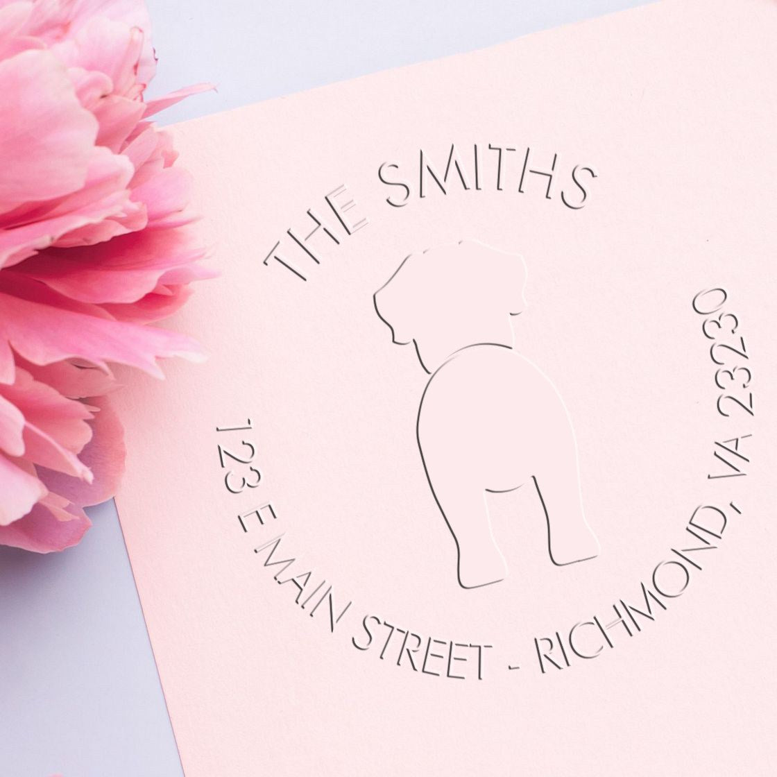 Blush pink custom stamp and seal with The Smiths address, elephant logo, and embossed lettering beside pink peonies.