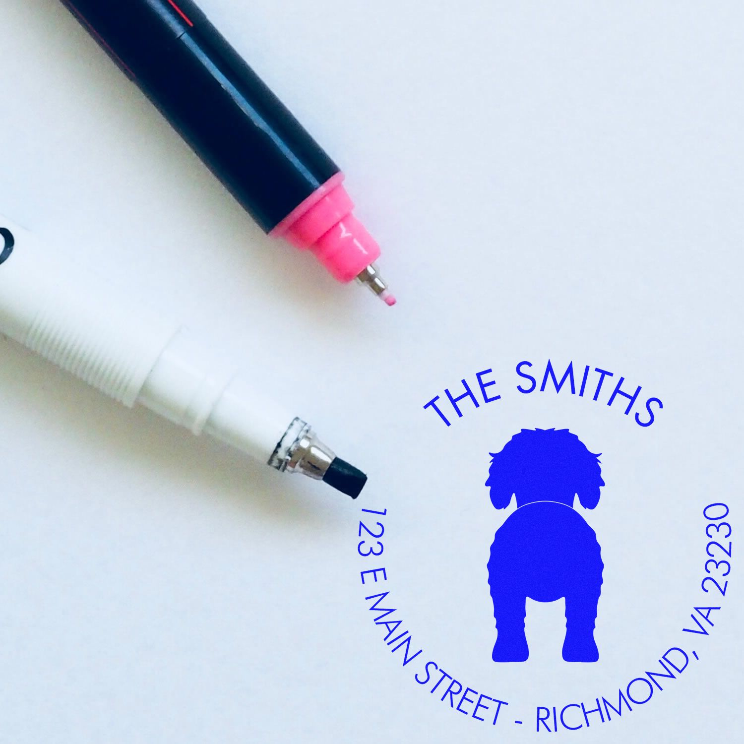 Goldendoodle dog stamp with a wood handle, custom return address rubber stamp by ESS, showing the stamped image in use.
