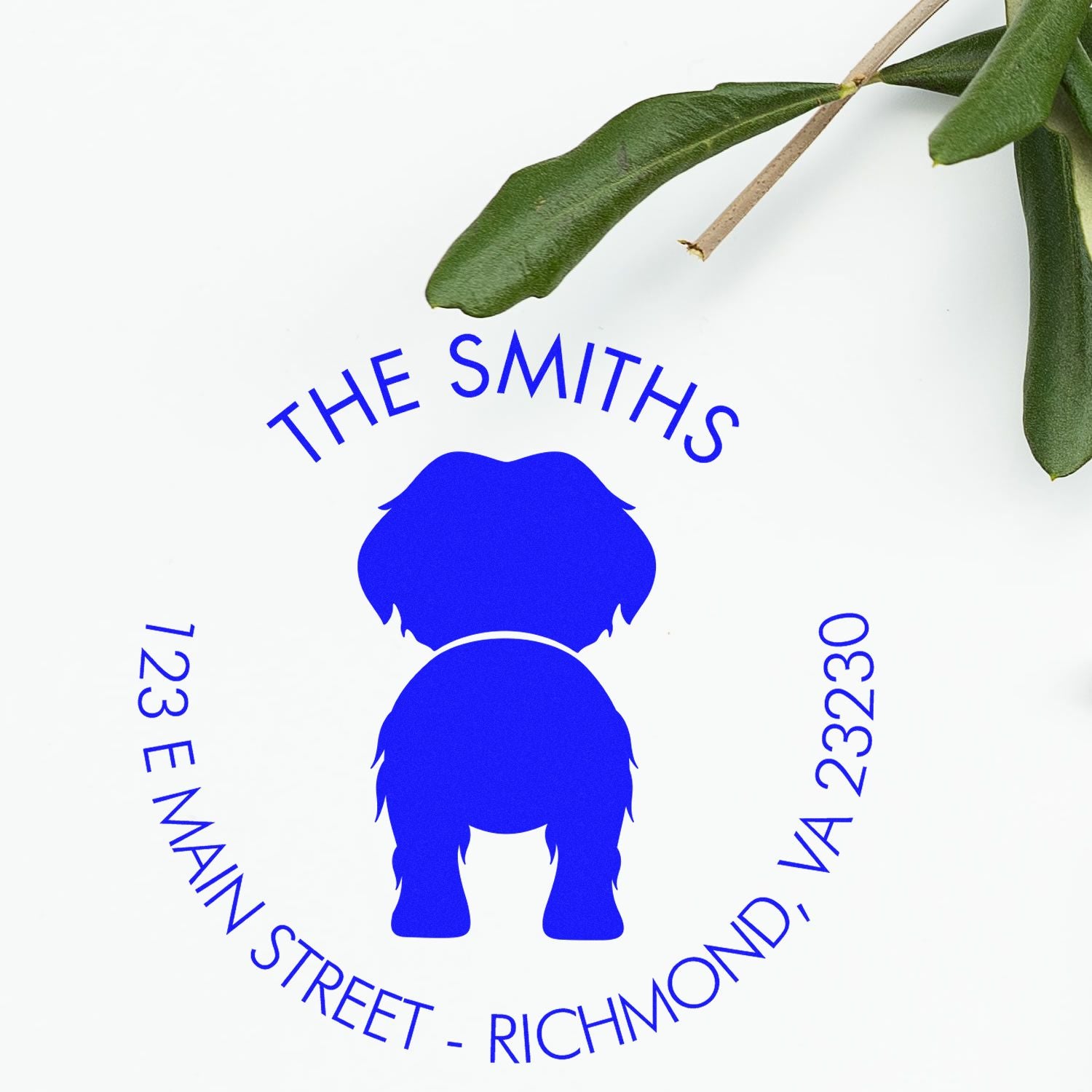Blue custom stamp and seal with dog silhouette, THE SMITHS, 123 E Main Street, Richmond, VA 23230, on white with green leaves.