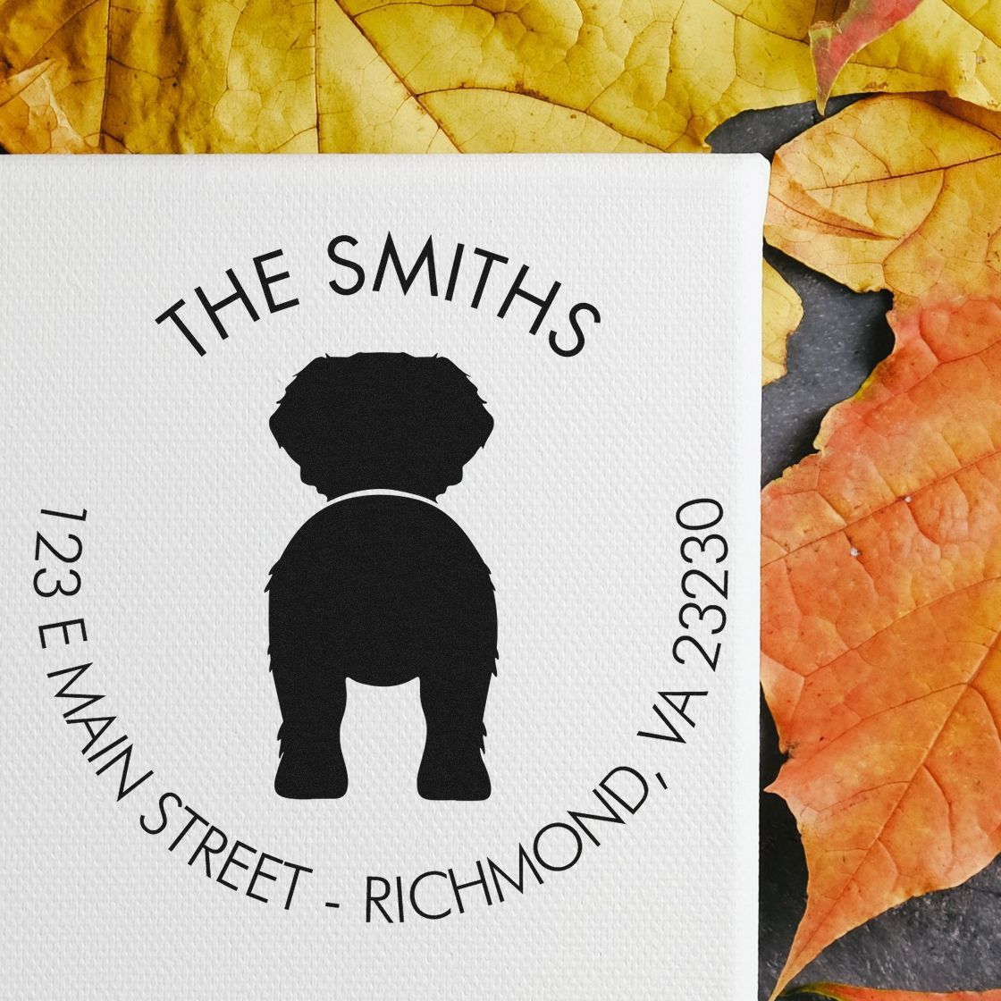 Custom black dog address stamp and seal on white textured paper, with ĀThe SmithsĀ and autumn yellow-orange leaves.