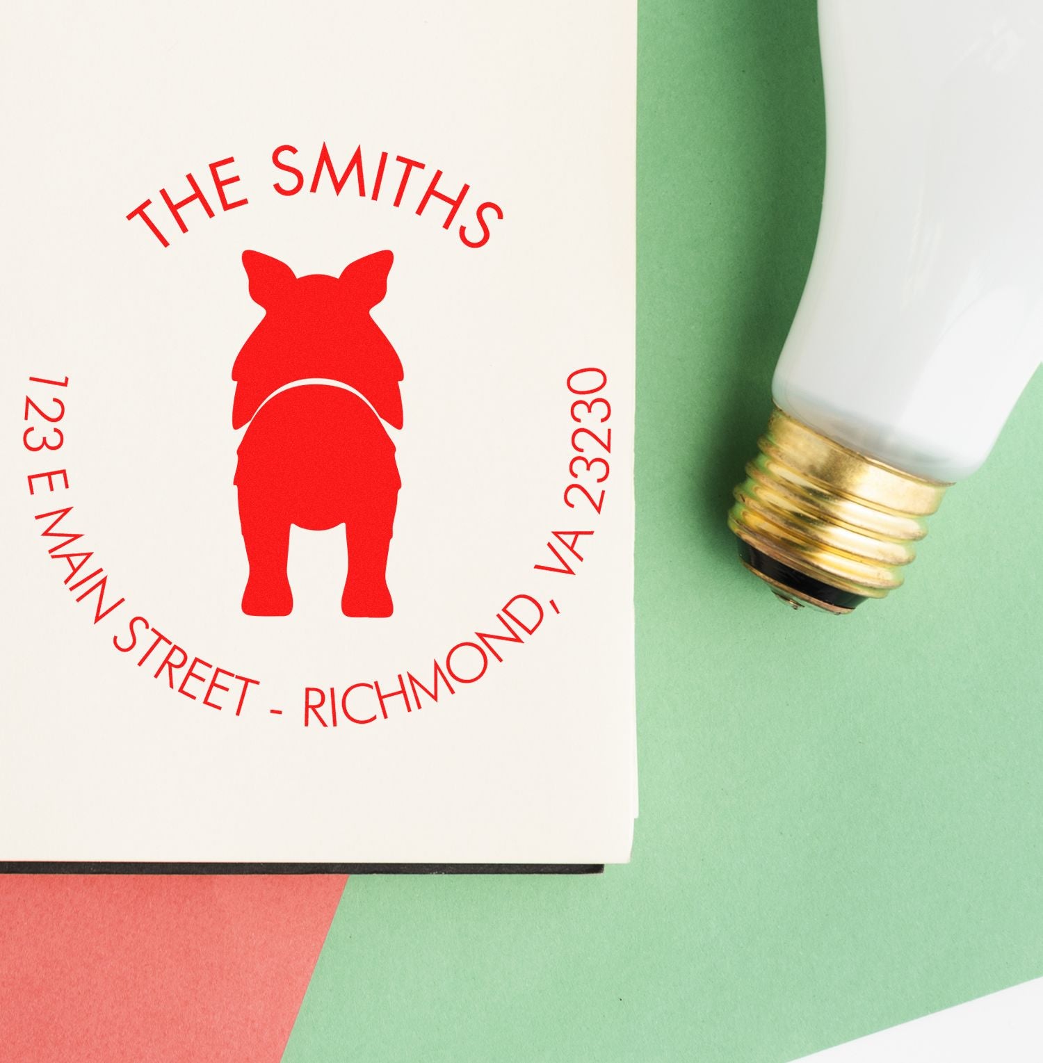 Red custom stamp seal for The Smiths with pig logo and address, beside a white-and-gold seal cap on green background.