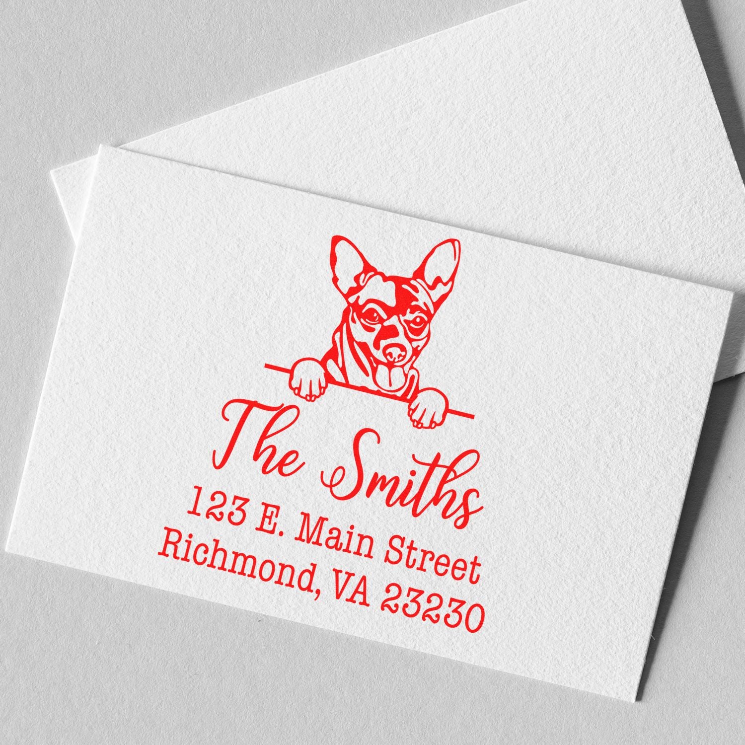 Red custom stamp seal on white textured paper, featuring a dog logo and The Smiths address.