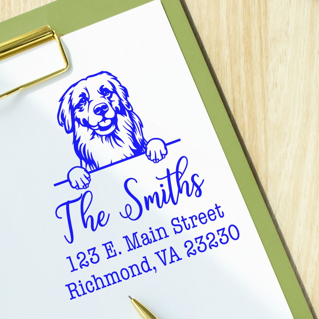 Blue custom address stamp for The Smiths with dog logo, on white paper with green border and gold clip.