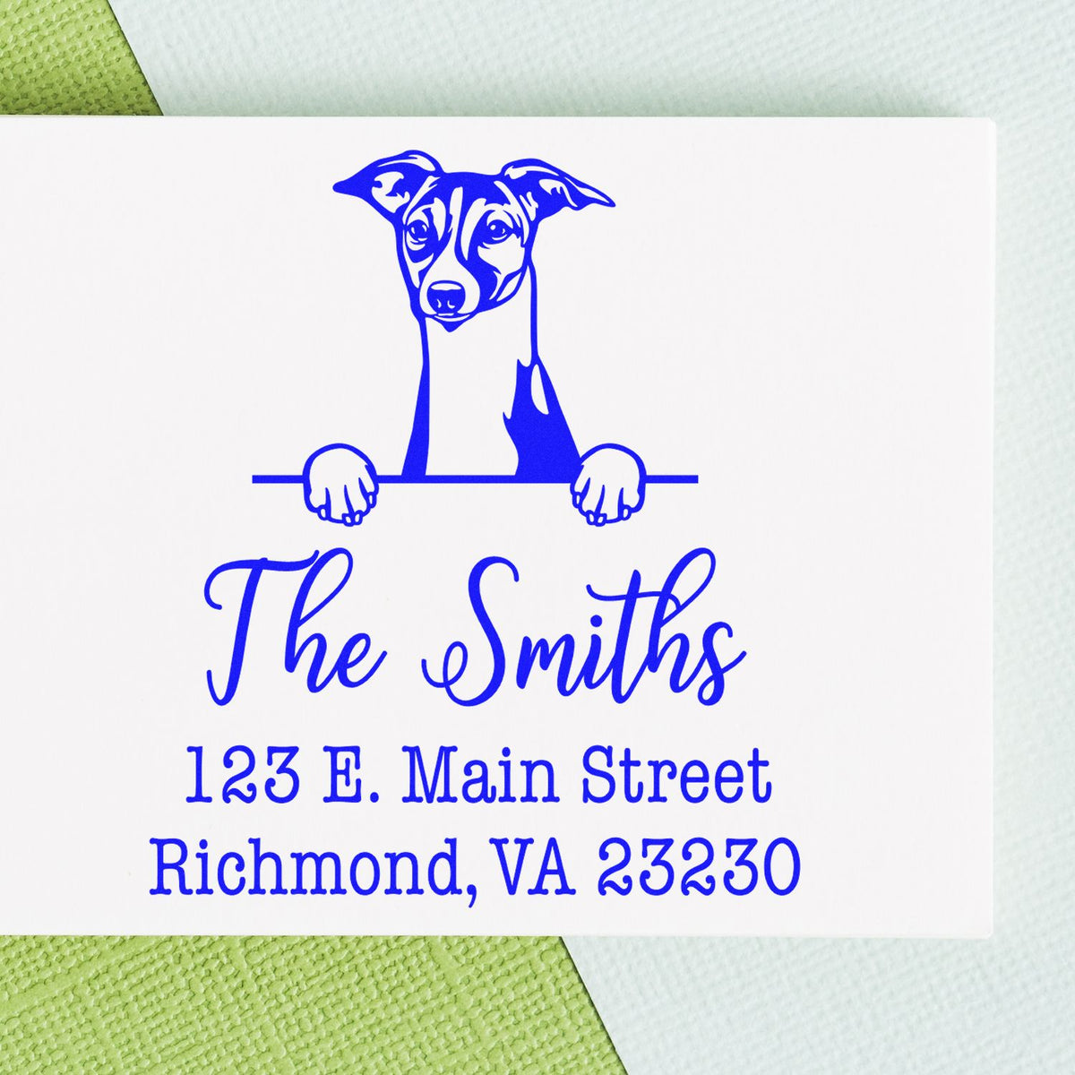 Trodat self-inking Italian Greyhound dog stamp in use, showcasing detailed handcrafted design on an envelope.