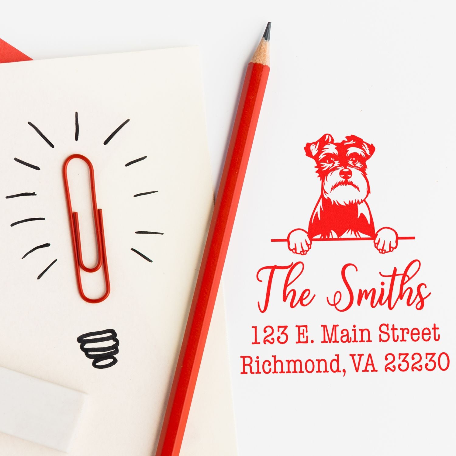 Custom red address stamp and seal with dog logo, The Smiths, Richmond VA, beside red pencil and paperclip lightbulb sketch.