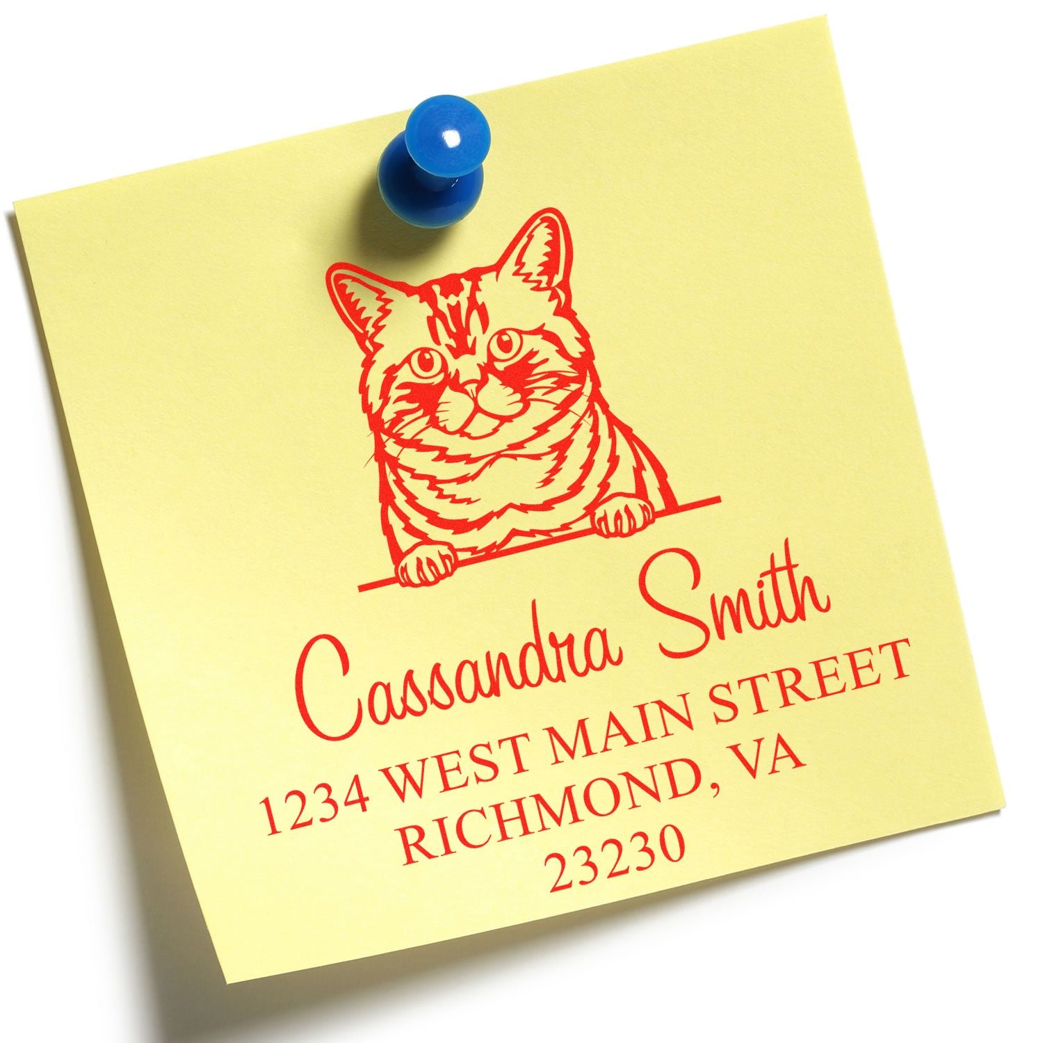 Custom red cat stamp and seal on pale yellow note, pinned with a blue pushpin, with red name and address text.
