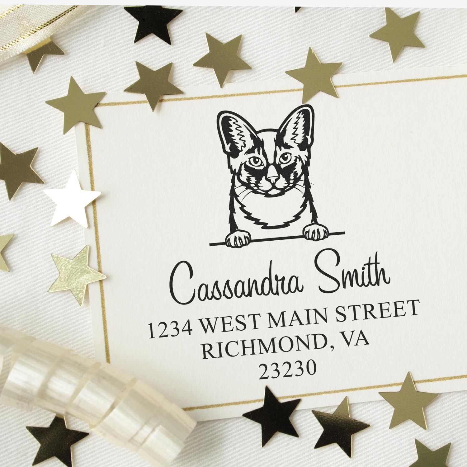 Custom cat address stamp and seal in black on white card with gold border, surrounded by gold and black star confetti.