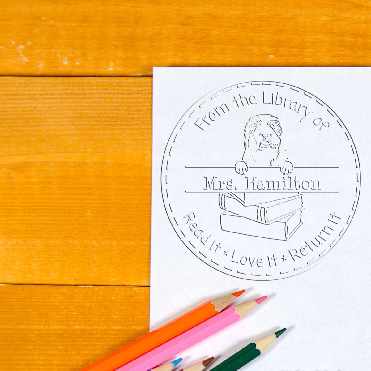 Old English Sheepdogs dog stamp by Trodat in use on paper, featuring detailed embossed design for educational or crafting purposes.