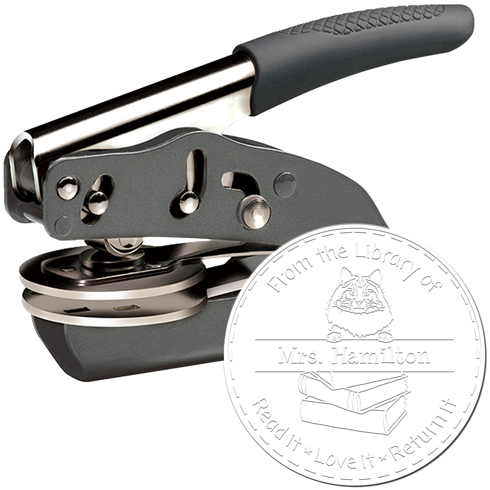 Gray handheld embosser stamp with black grip and silver metal seal, custom library bookplate design with cat and books.