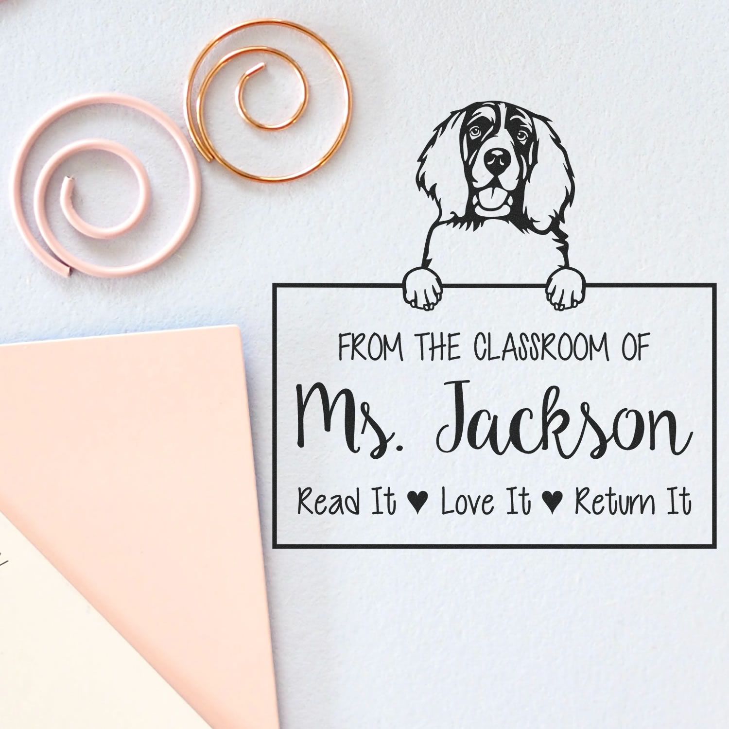 Custom black classroom stamp seal with dog and Ms. Jackson text, beside pink and gold spiral seal samples on white background.