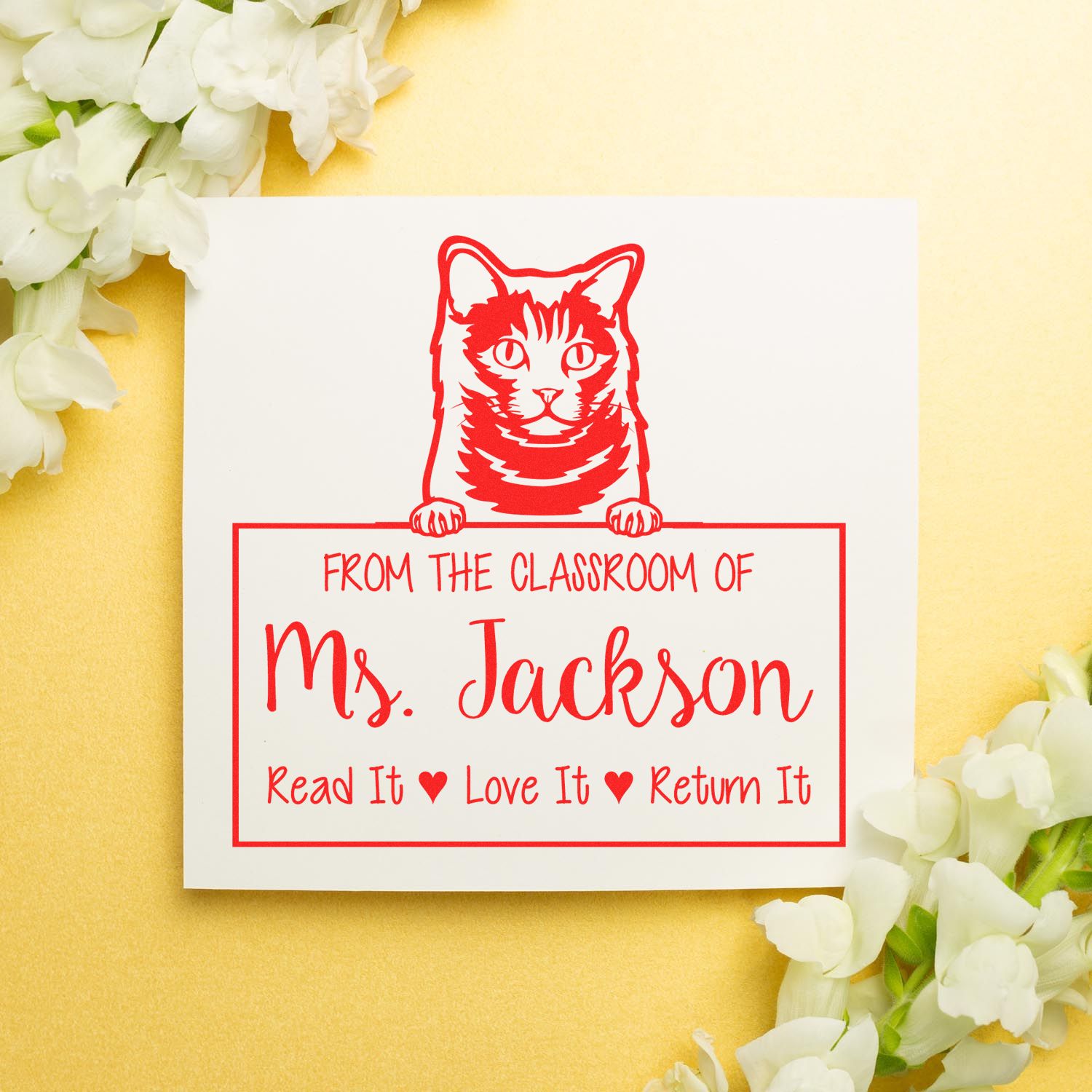 Red cat classroom stamp and seal for Mrs. Jackson, with white flowers and a soft gold background.