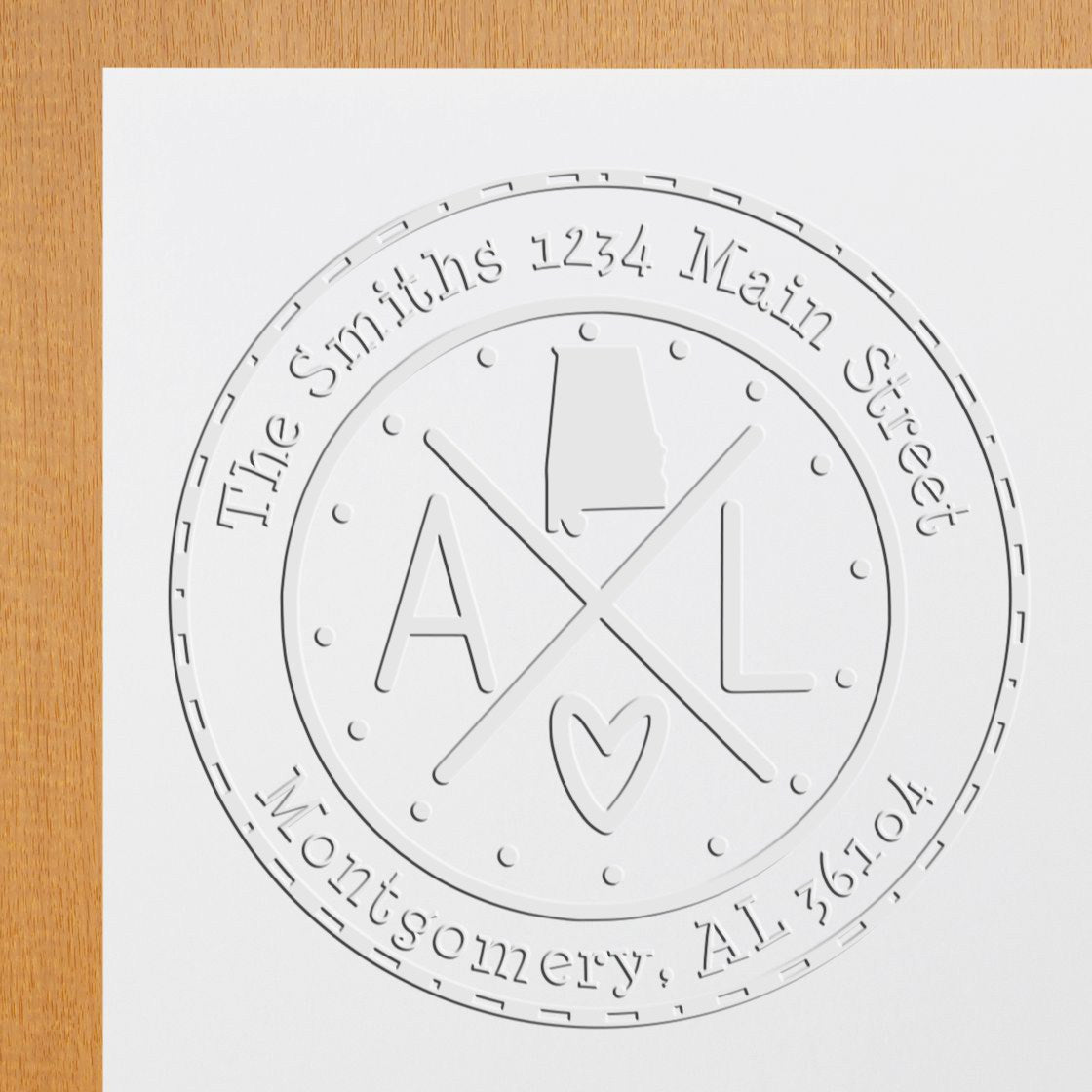 Embossed white circular seal stamp with AL monogram and heart, reading Smith's 1234 Main Street, Montgomery, AL 36104.