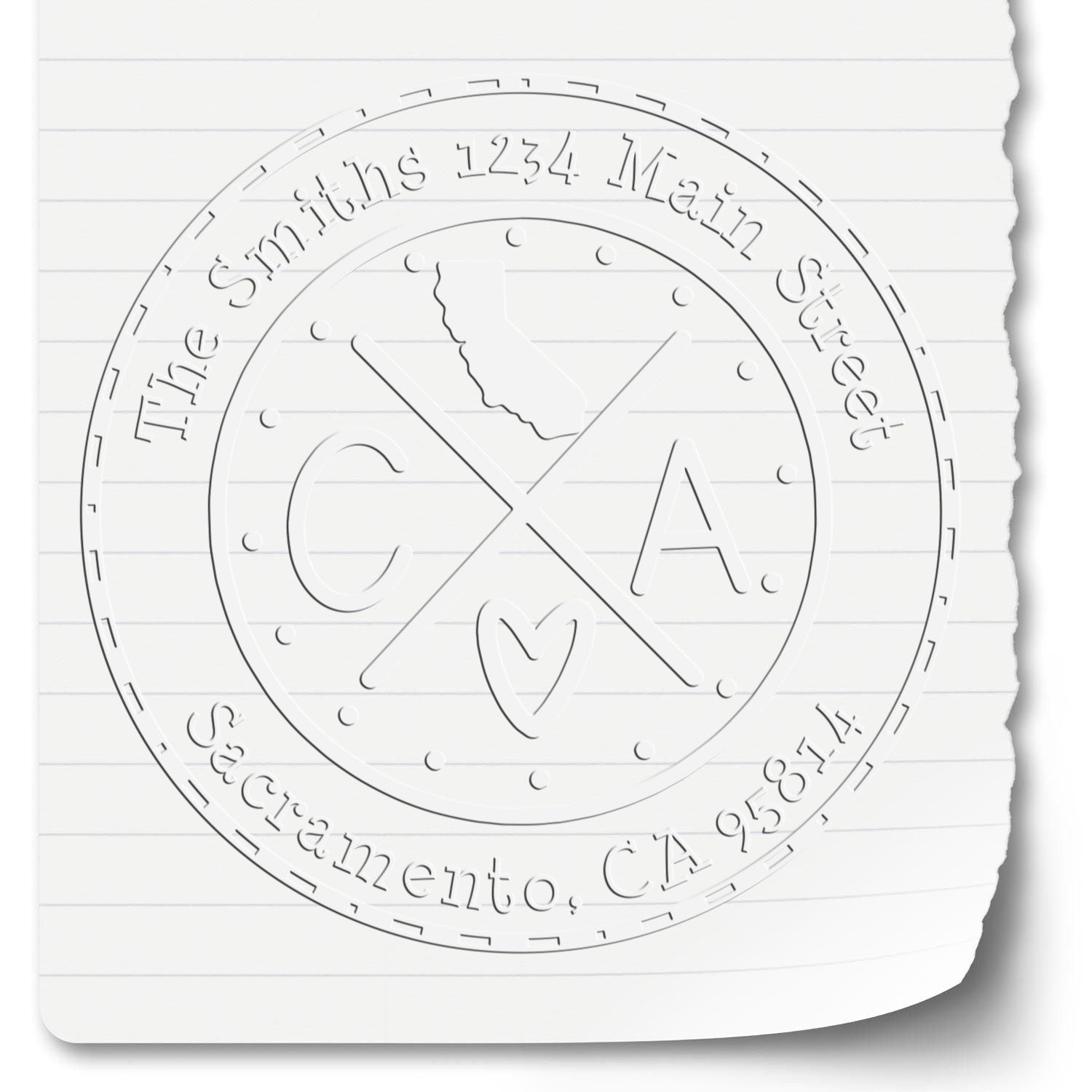 White embossed circular custom stamp seal with crossed C and A, heart, and address text on lined paper.