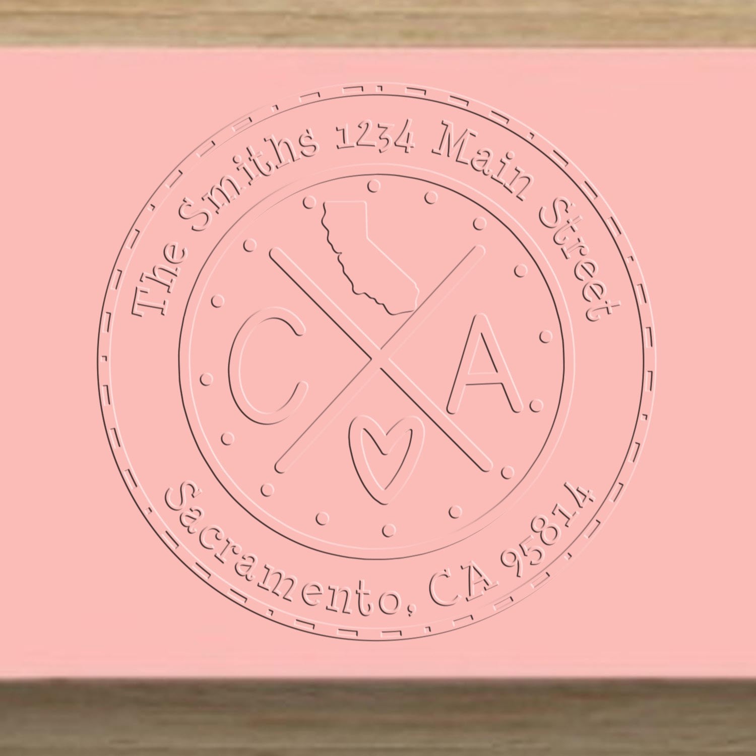 Pink embossed circular stamp seal for The Smiths, 1234 Main Street, Sacramento CA 95814, with California outline and heart.