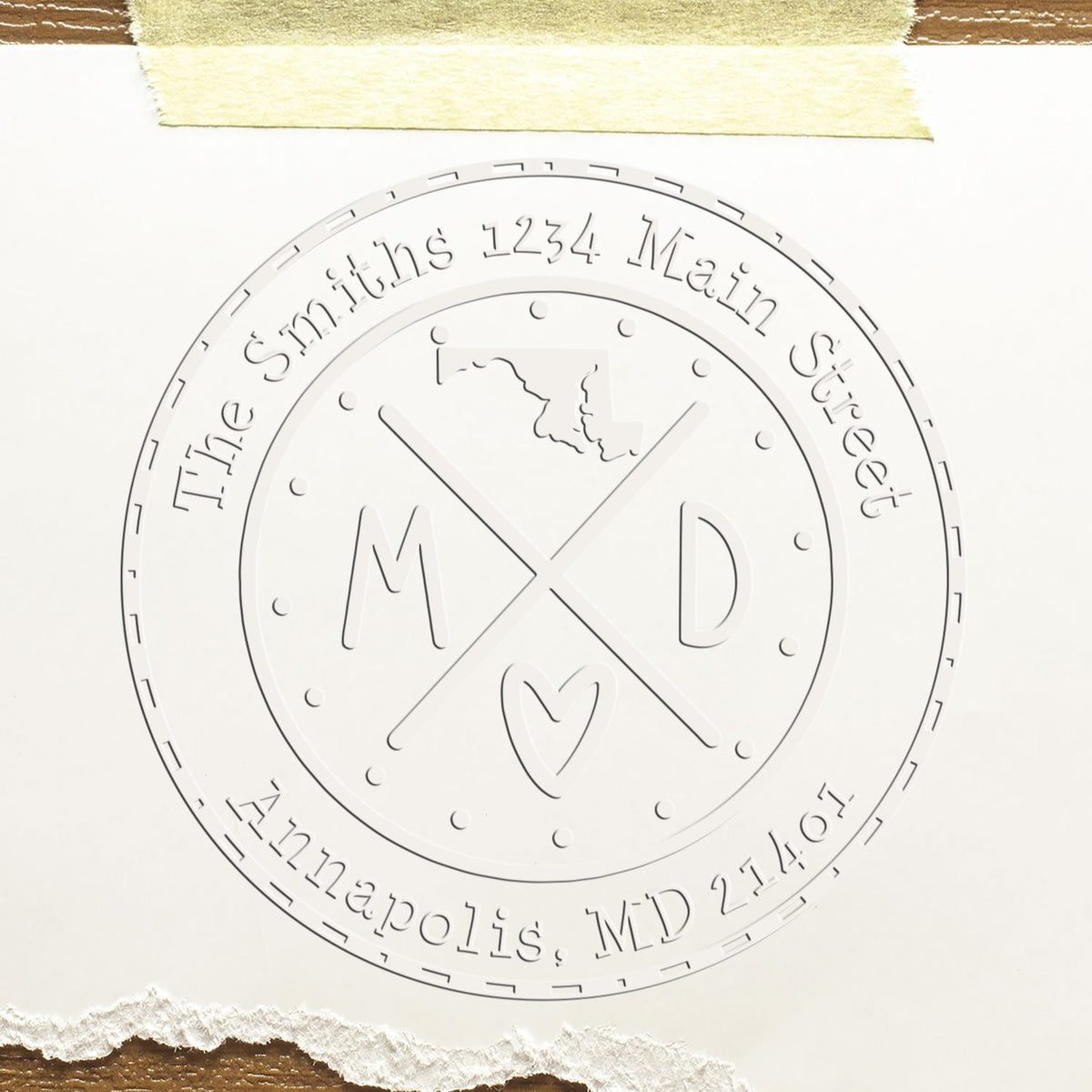 Embossed white circular stamp seal for The Smiths, 1234 Main Street, Annapolis, MD 21401, with crossed initials M and D.