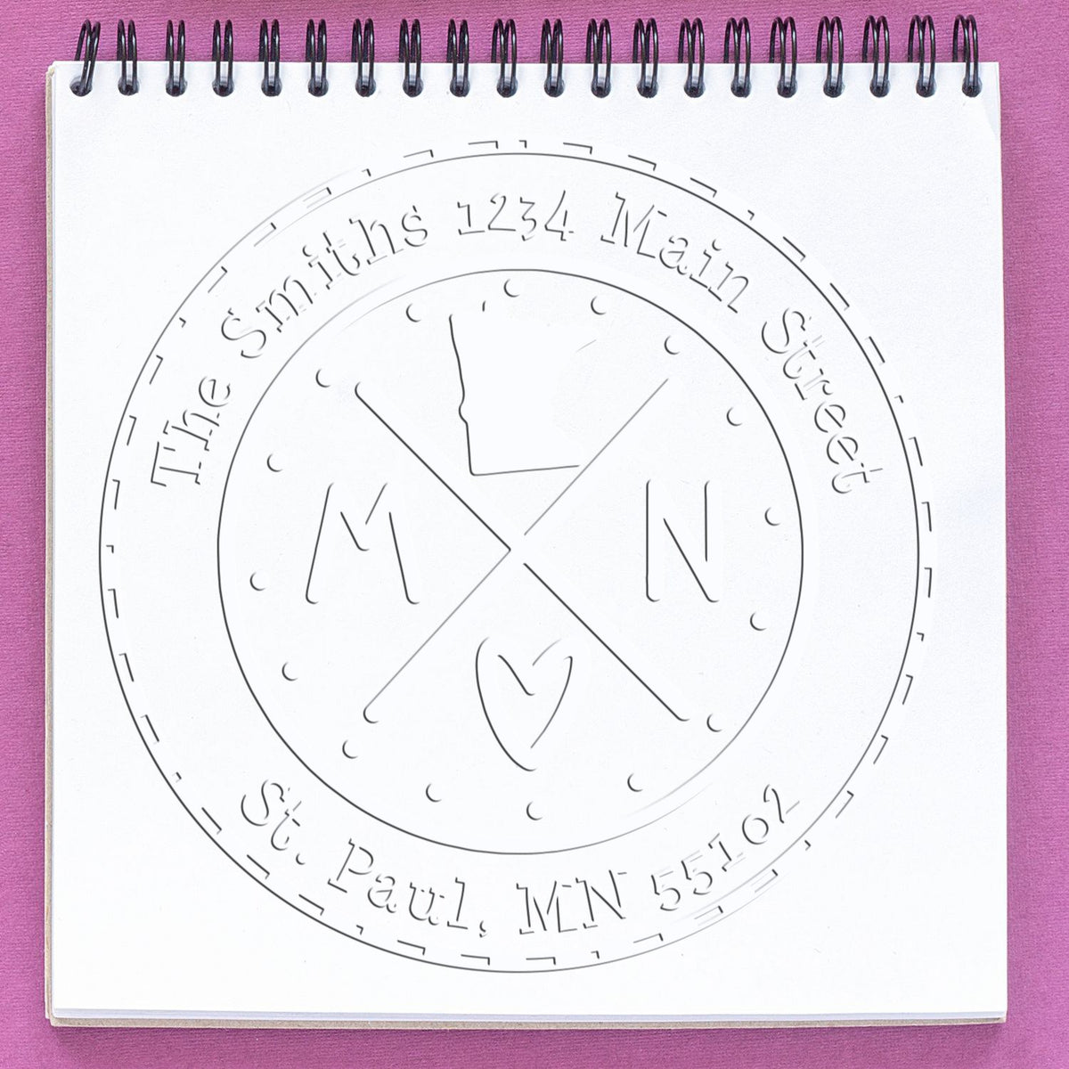 Trodat State Cross Hybrid Minnesota address embossing stamp from State Love Stamps in use, featuring customizable design and raised embossing surface.