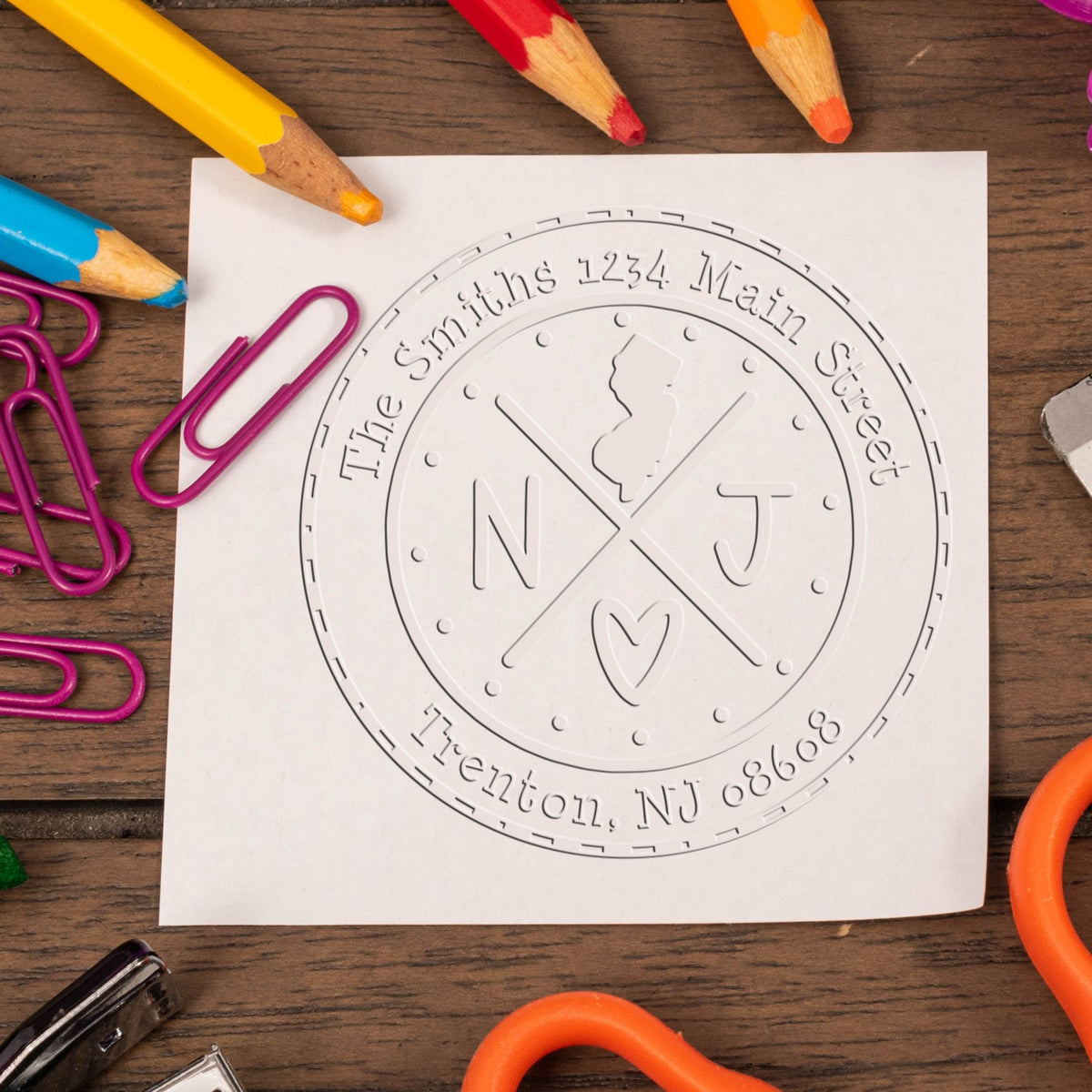 Trodat State Cross Hybrid New Jersey return address stamp embossing a mailing label with state seal design.