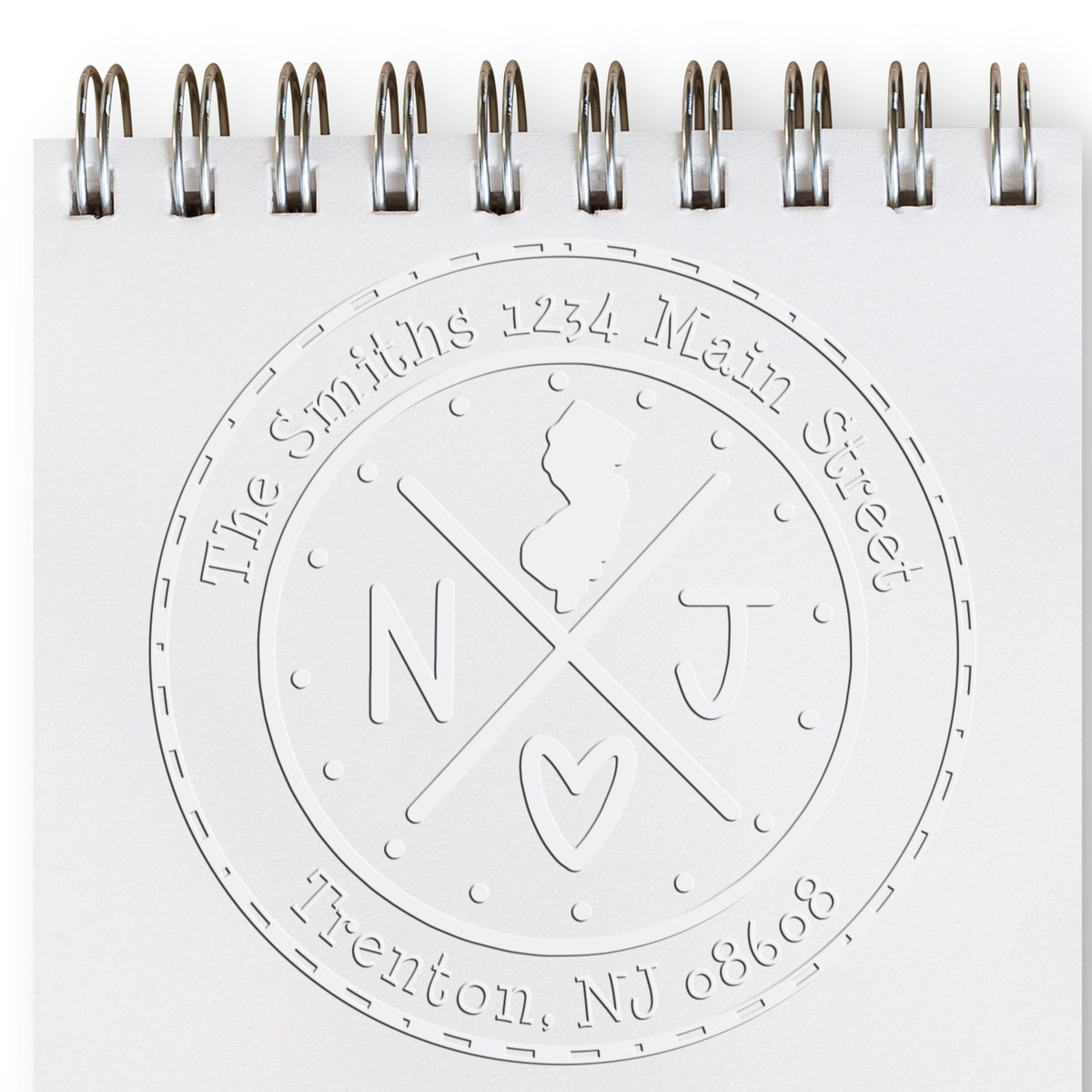Trodat State Cross Hybrid New Jersey return address stamp embossing a mailing label with state seal and custom text.