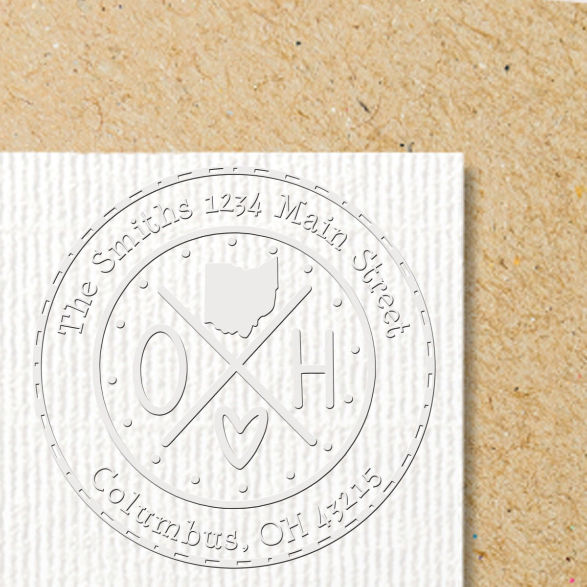 Trodat State Cross Hybrid Ohio return address embossing stamp in use, showcasing customizable design with state and address details.