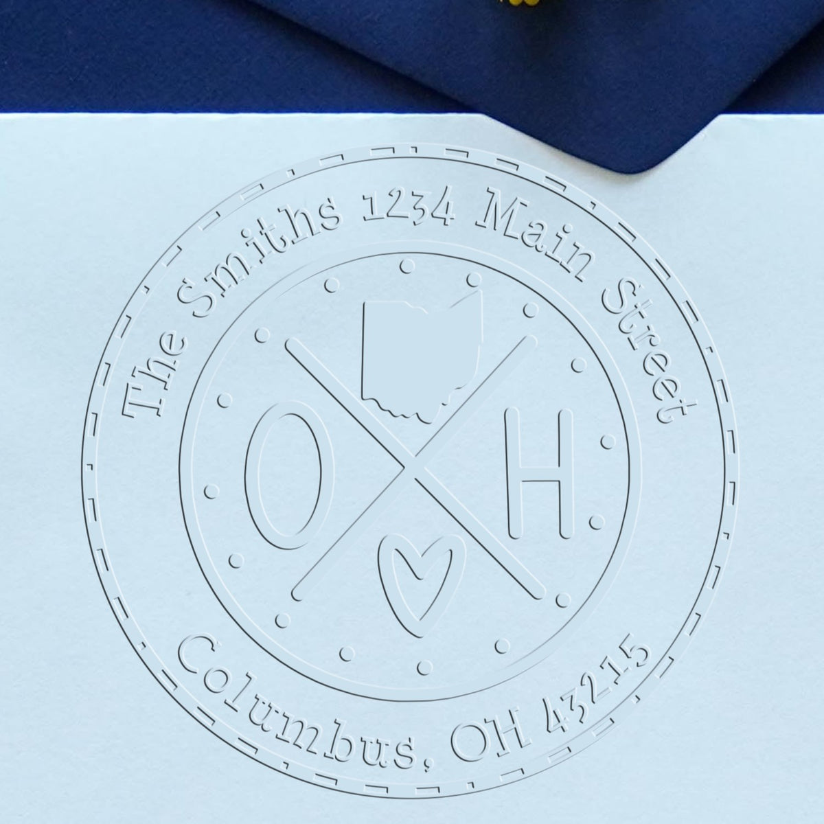 Trodat State Cross Hybrid Ohio return address embossing stamp from State Love Stamps, in use with raised embossed design visible.