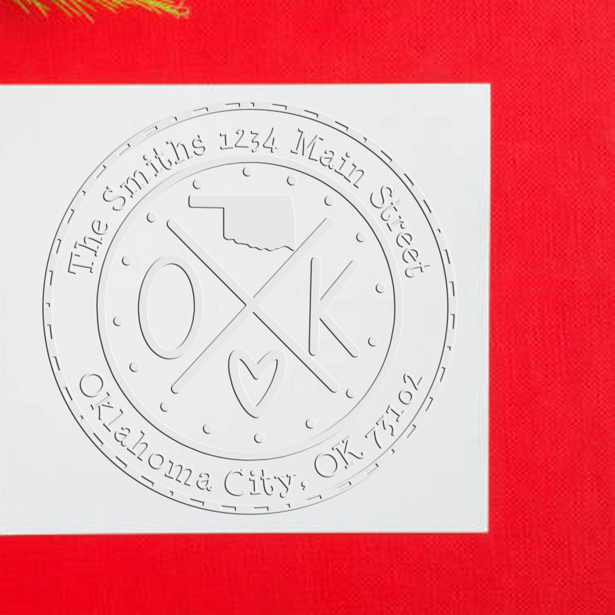Trodat State Cross Hybrid Oklahoma return address embosser seal stamp in use, showcasing detailed state and custom design features.
