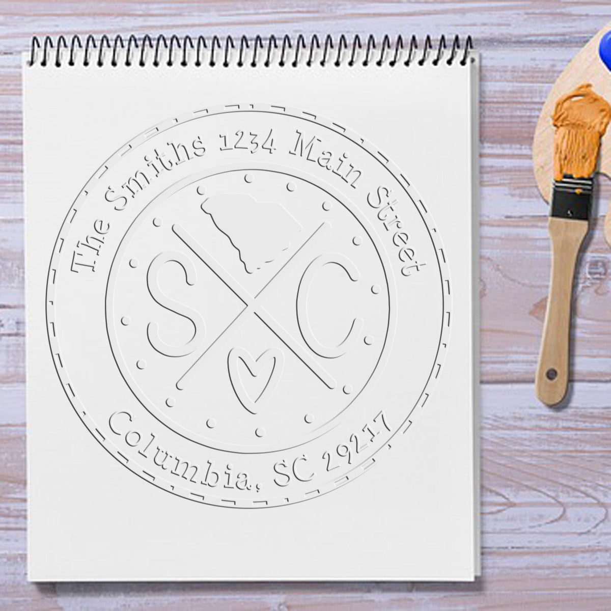 Trodat State Cross Hybrid Customizable Address Return Embosser Seal for South Carolina, showing the embossed seal in use