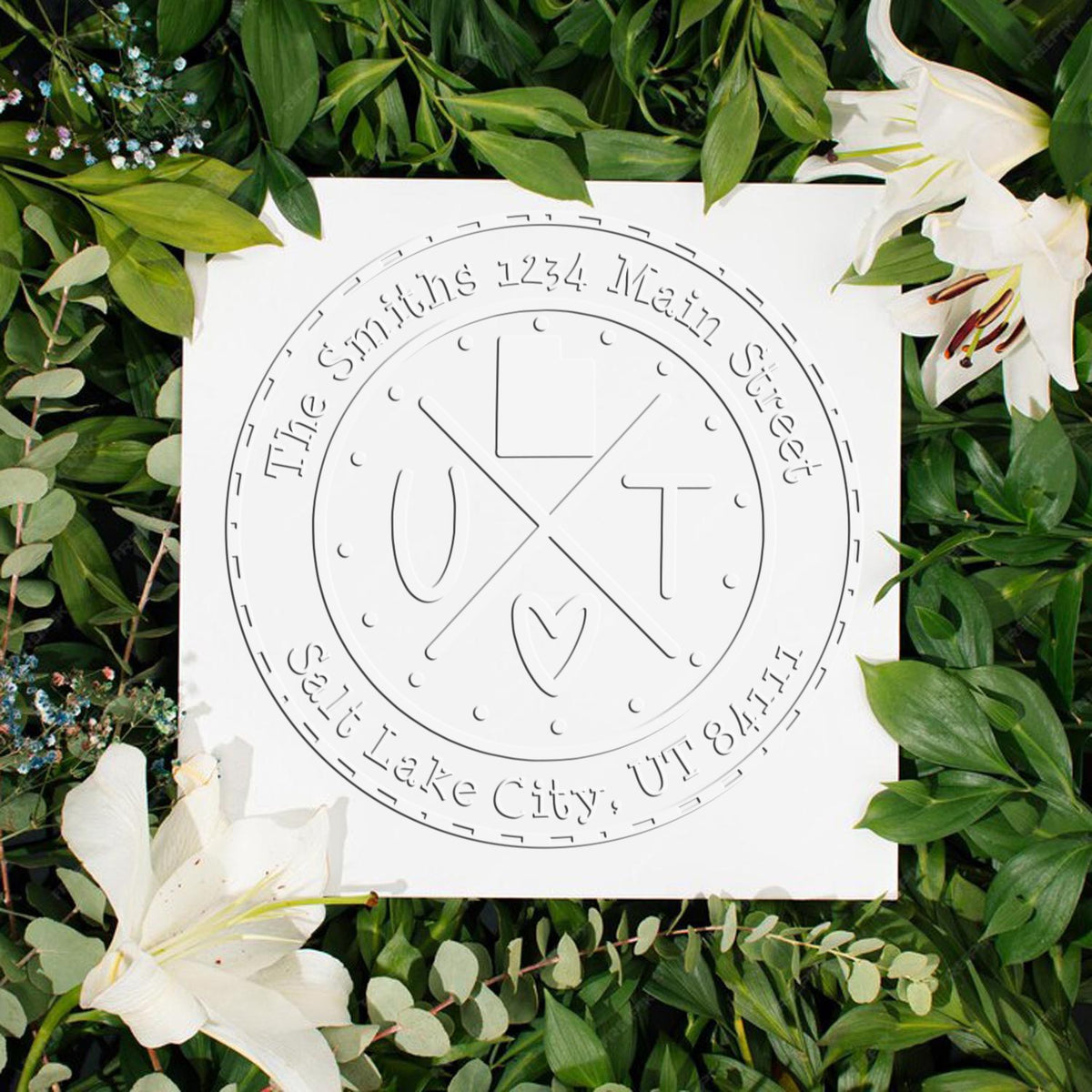 Custom round white stamp seal with The Smith's 1234 Main Street logo, surrounded by green leaves and white lilies.