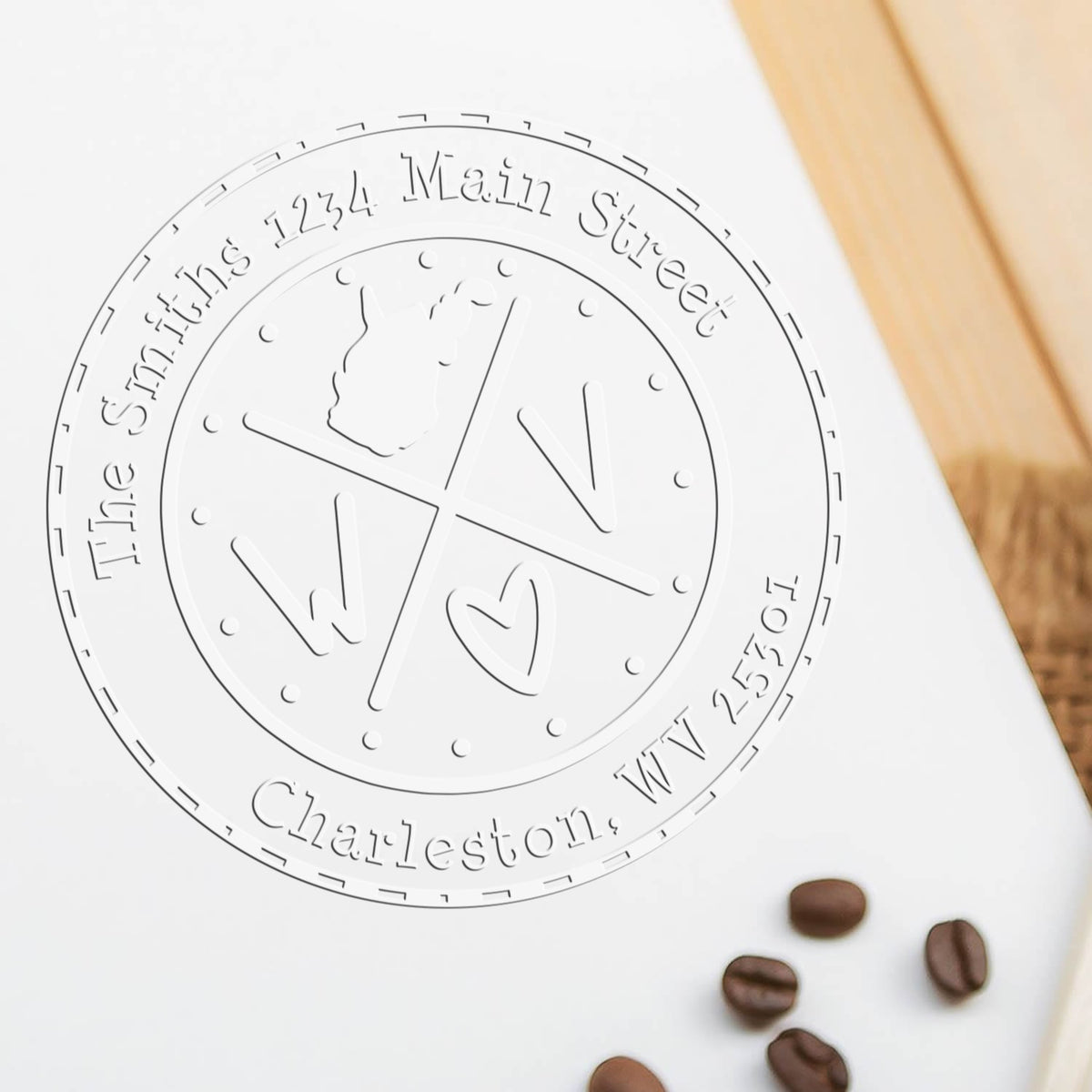 White embossed custom stamp seal for The Smiths, 1234 Main Street, Charleston, WV, with coffee beans on a white background.