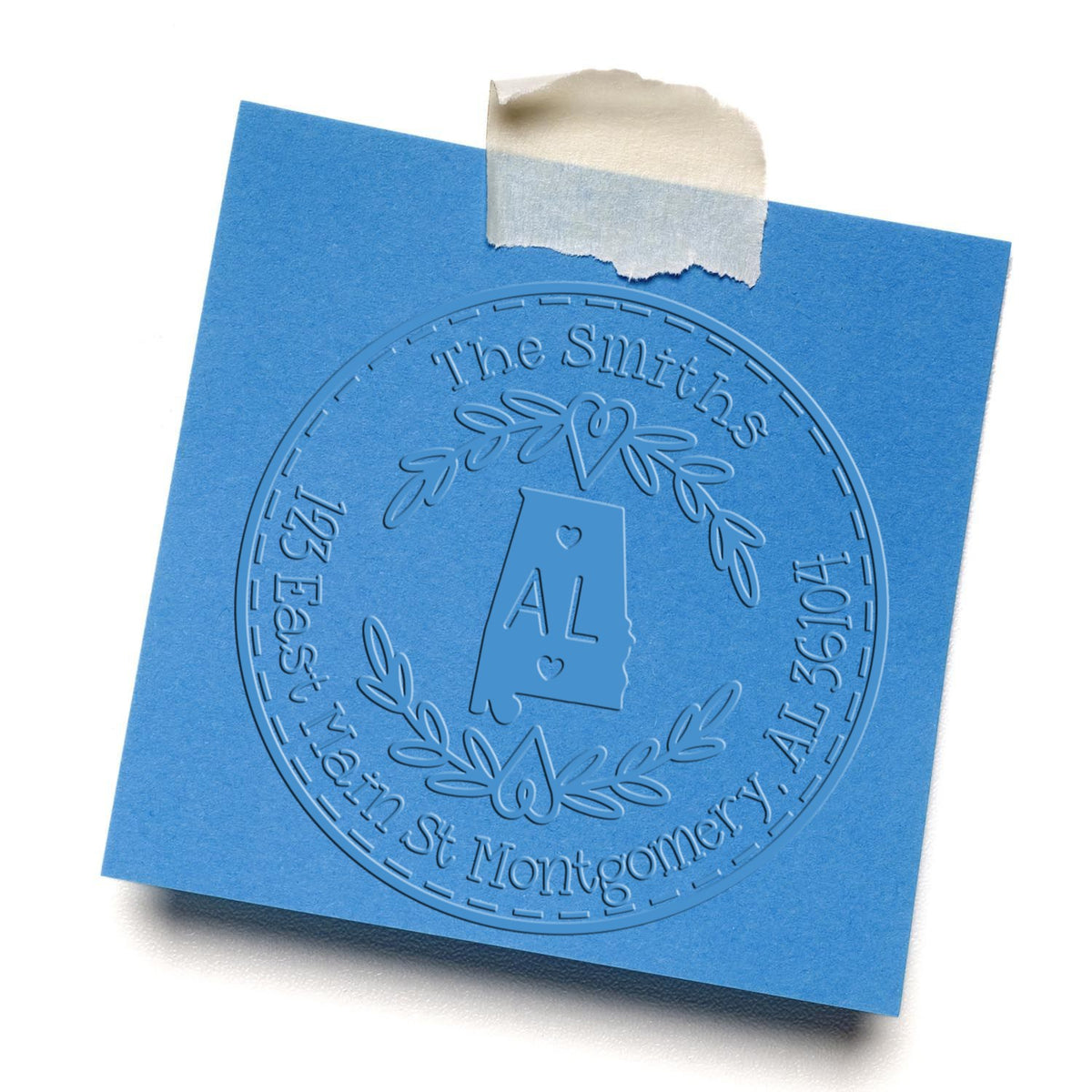 Blue embossed custom stamp and seal for Alabama, taped to a blue card with laurel wreath and monogram initials.