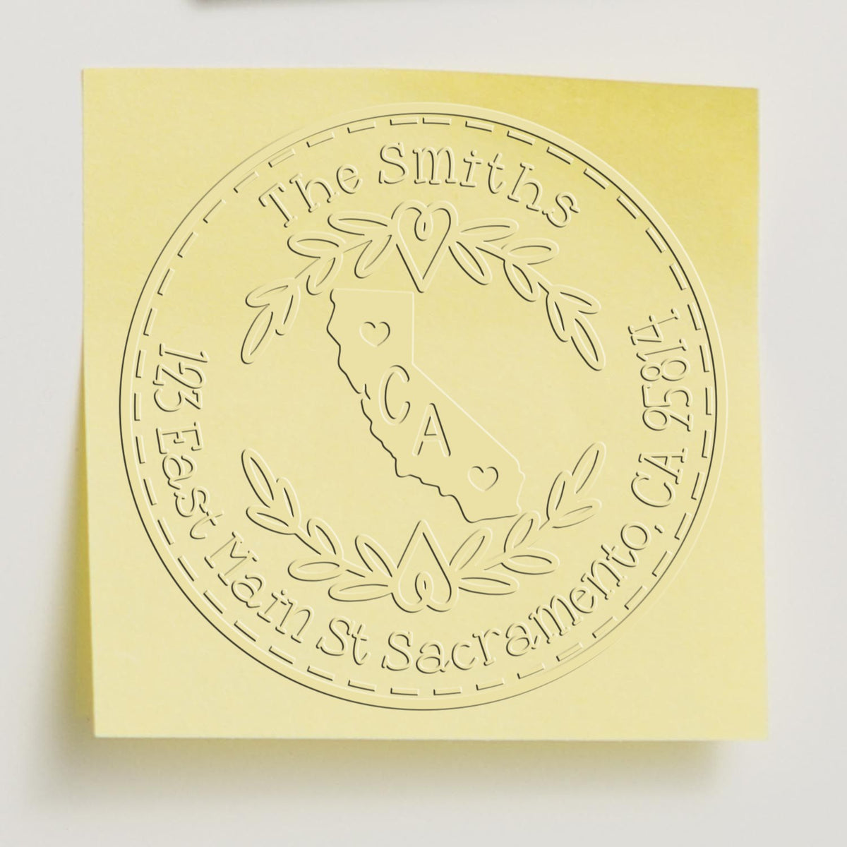 Pale yellow embossed custom stamp seal with circular The Smiths design, California outline, and laurel wreath