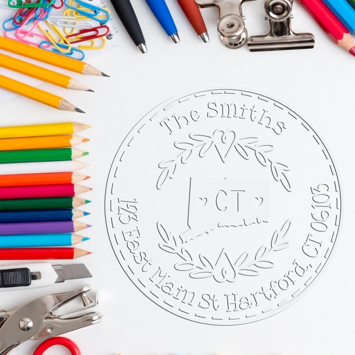 Trodat State Wreath CT Custom Return Address Stamp Embosser with state love design in use on paper.