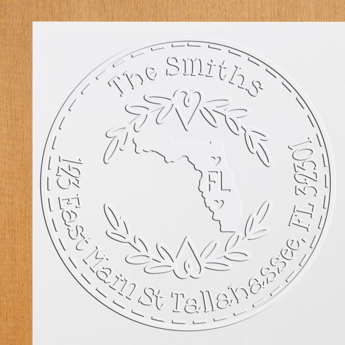Trodat State Love Stamps Florida embossed address seal with custom state-shaped design in use on a letter.