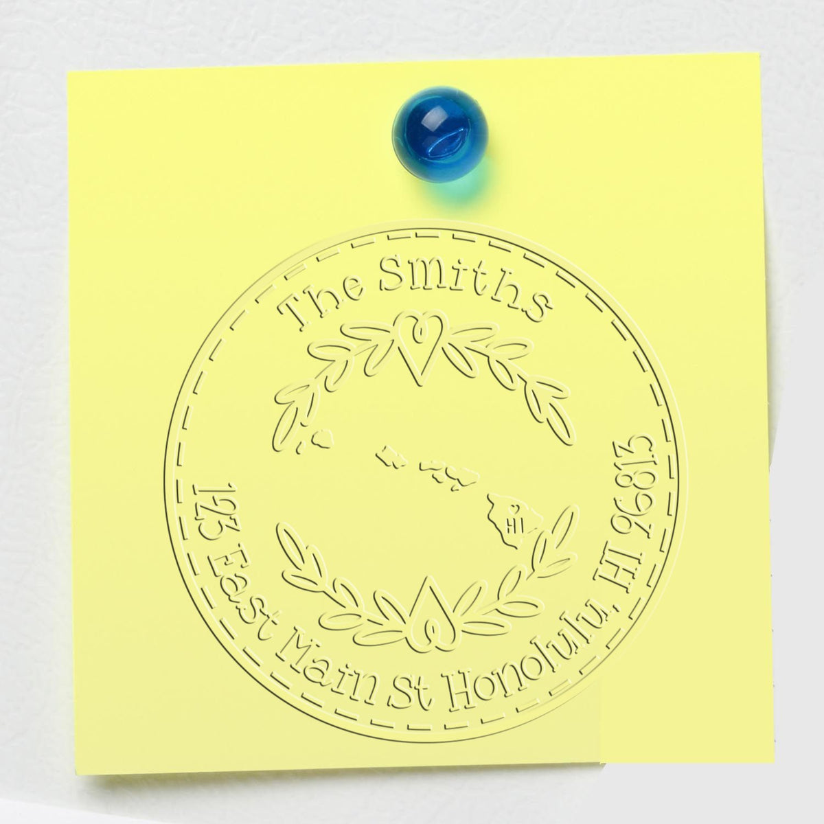 Yellow sticky note pinned with blue pushpin, embossed circular stamp seal reading The Smiths, East Main St Honolulu HI 96812.