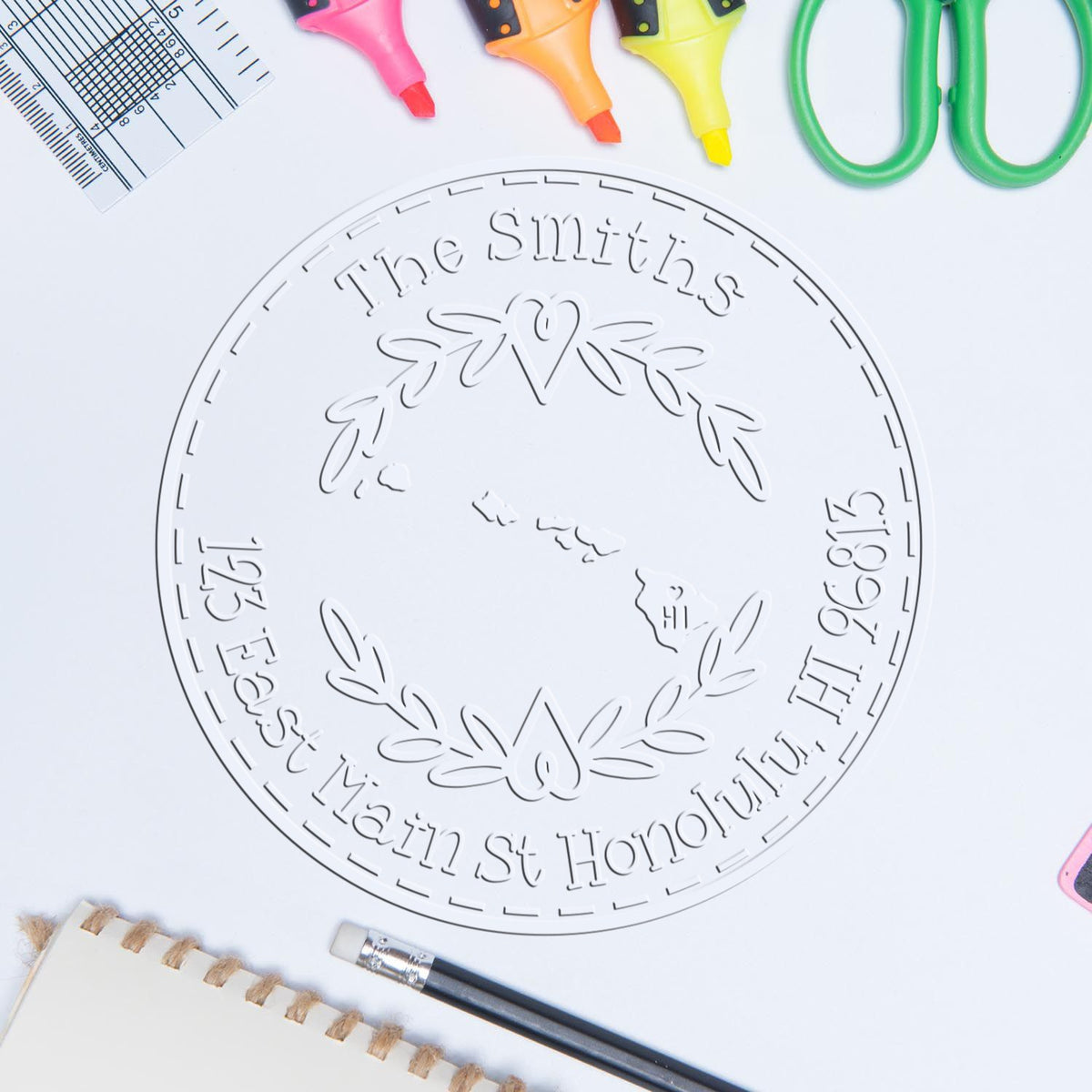 White embossed custom seal for The Smiths, with pink, orange, yellow stamp tools and green scissors on a white background