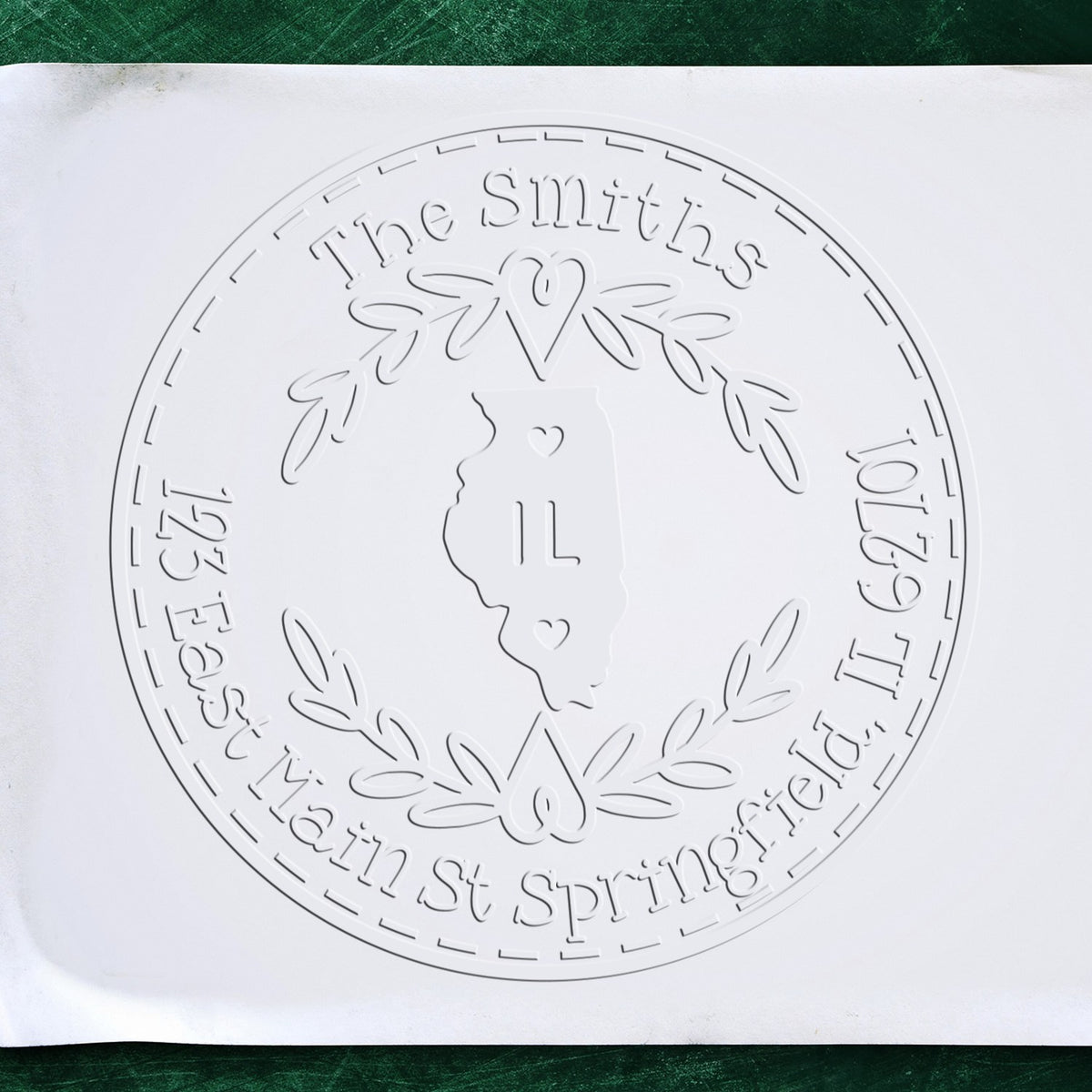 Trodat State Love Stamps IL custom return address embosser seal stamp in use, featuring a detailed Illinois state design.