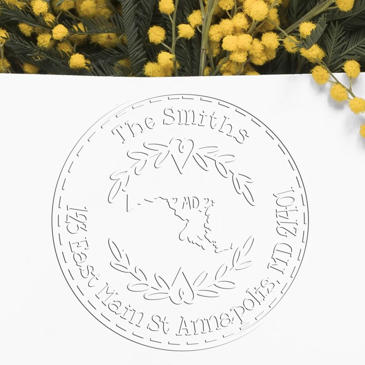 Trodat State Love Stamps MD custom address return seal embosser in use, featuring Maryland state outline and detailed embossing.