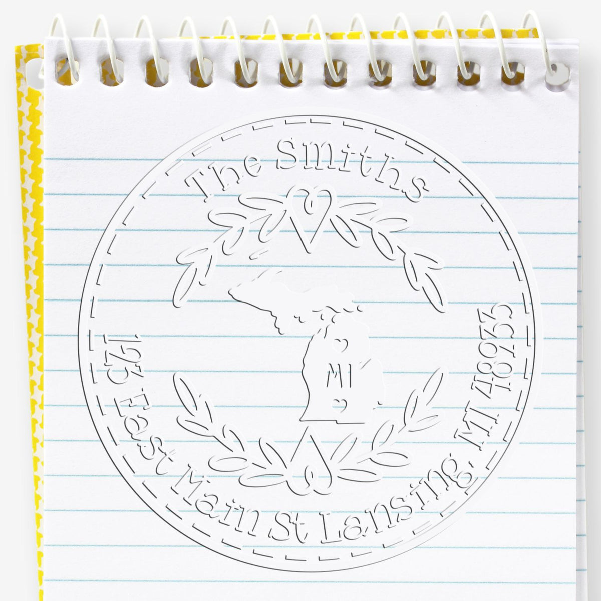 Trodat State Love Stamps MI custom address return embossing seal in use, featuring Michigan state design and embossed detail.