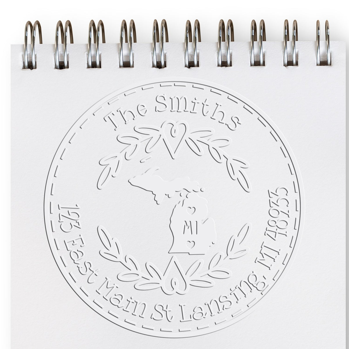Trodat State Love Stamps MI custom address return embossing seal in use, featuring Michigan state design and detailed embossing.