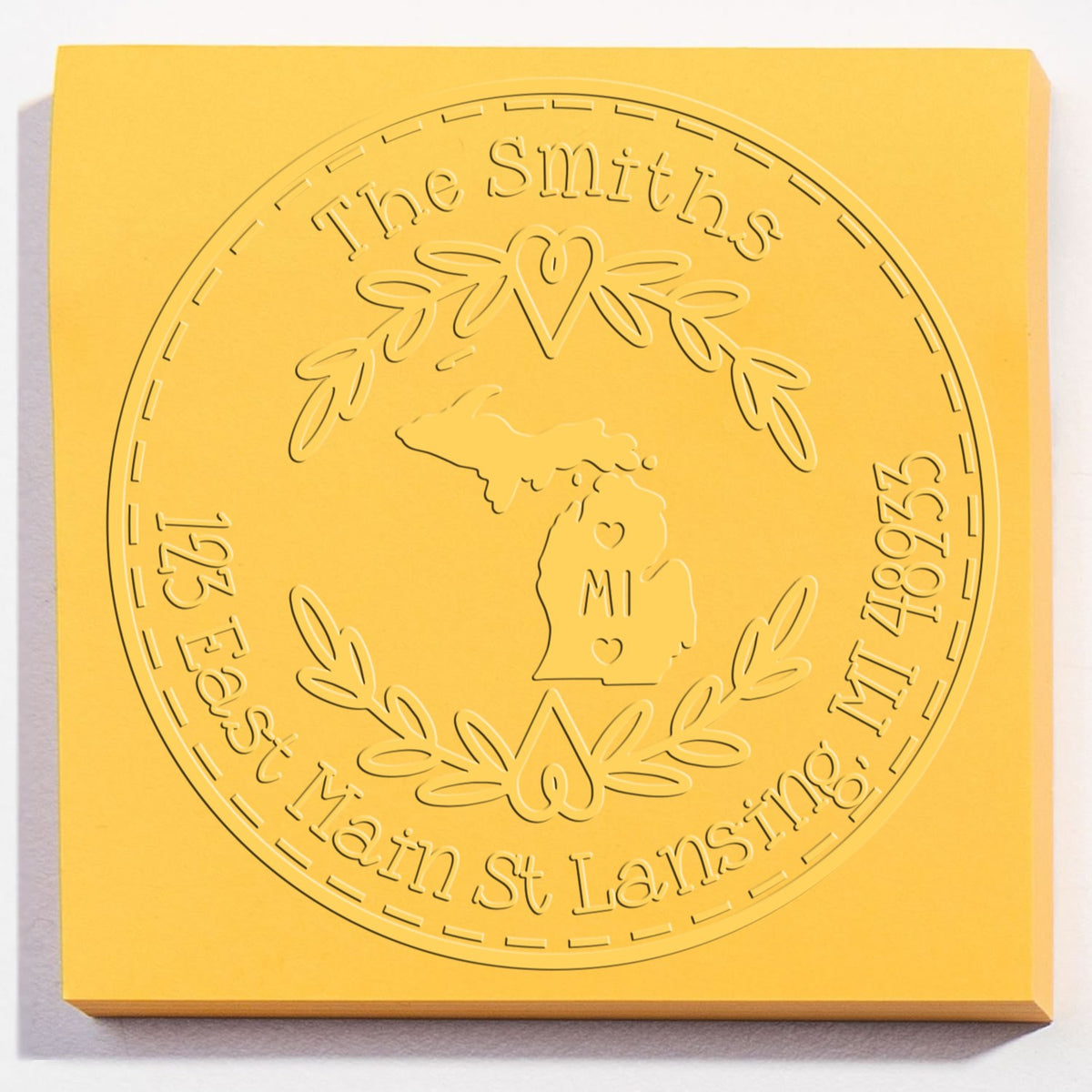 Trodat State Love Stamps MI custom address embossing seal in use, featuring Michigan state outline and decorative lettering.