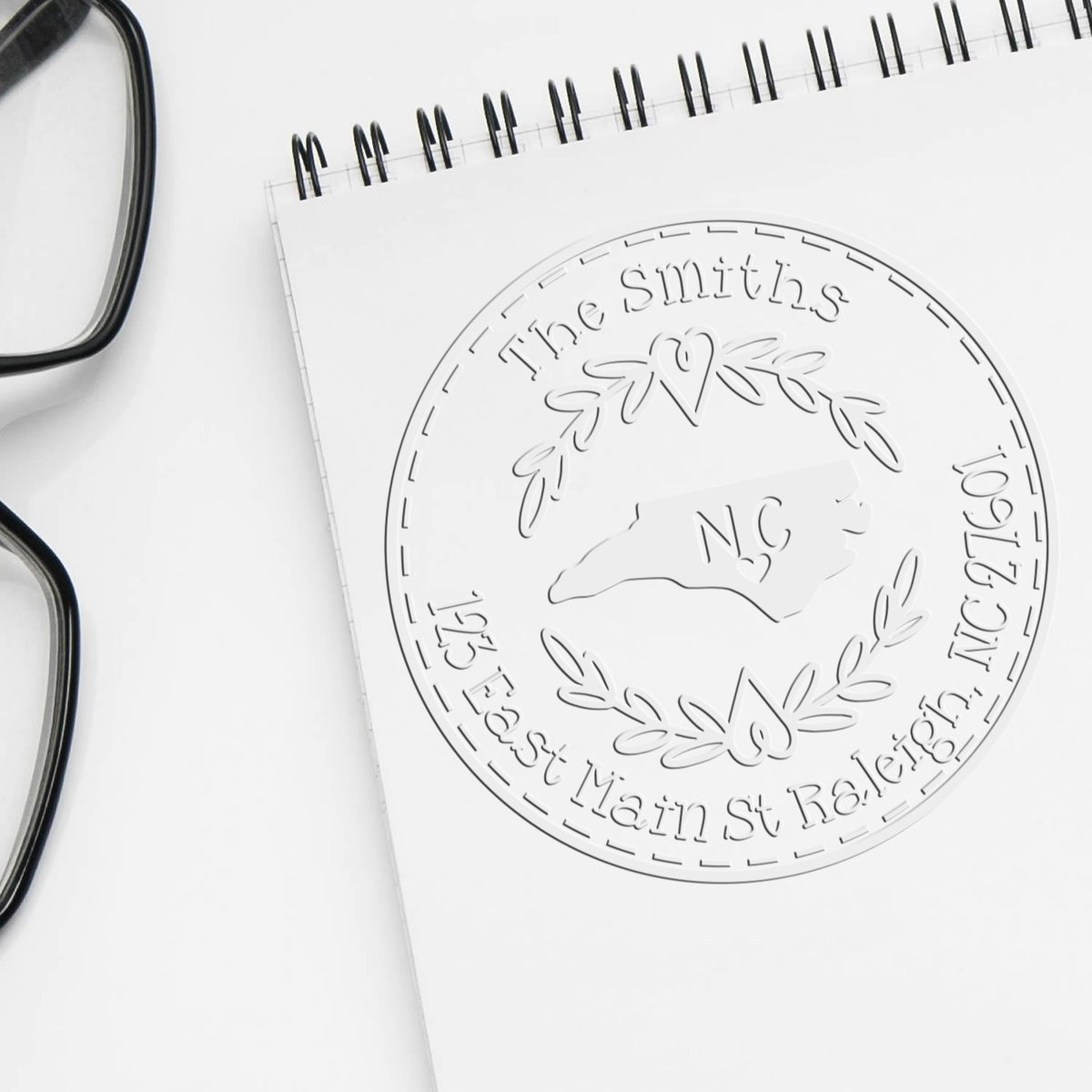 Trodat State Love Stamps NC custom mail address embossed seal with North Carolina state design in use.