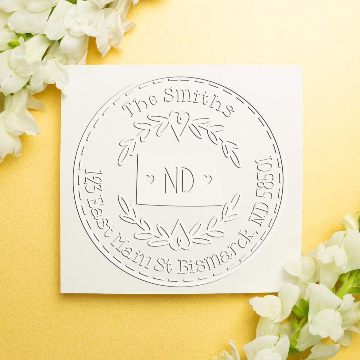 Trodat State Love Stamps ND custom mail address embossing seal in use, featuring an engraved state-themed design.