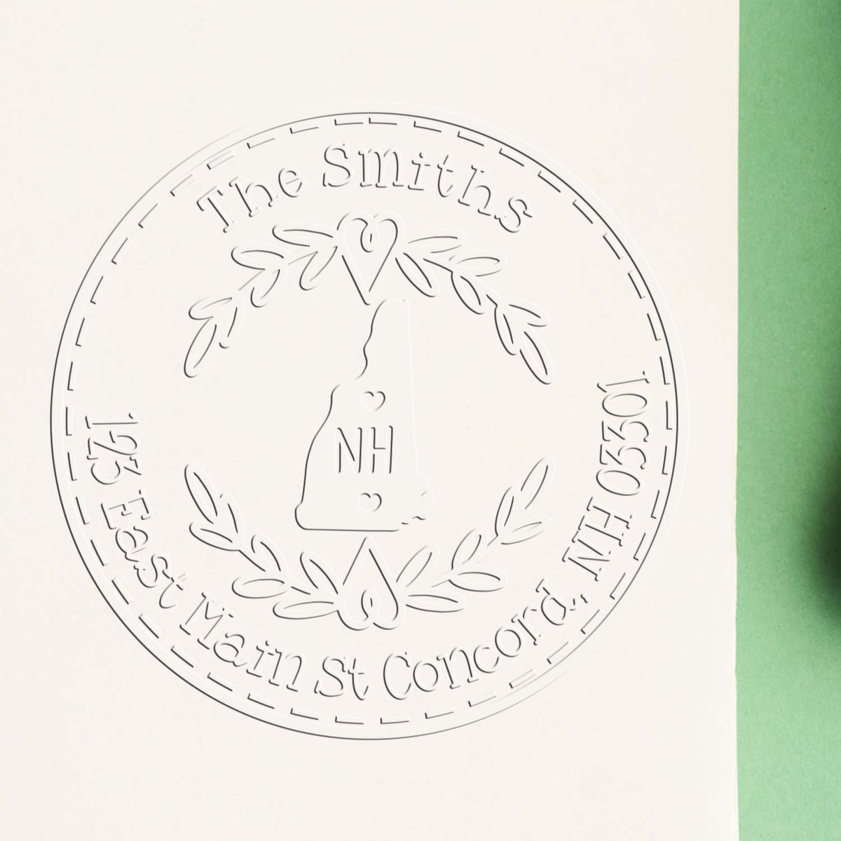 Embossed circular white seal stamp for The Smiths, with NH monogram, laurel wreath, and green paper edge.