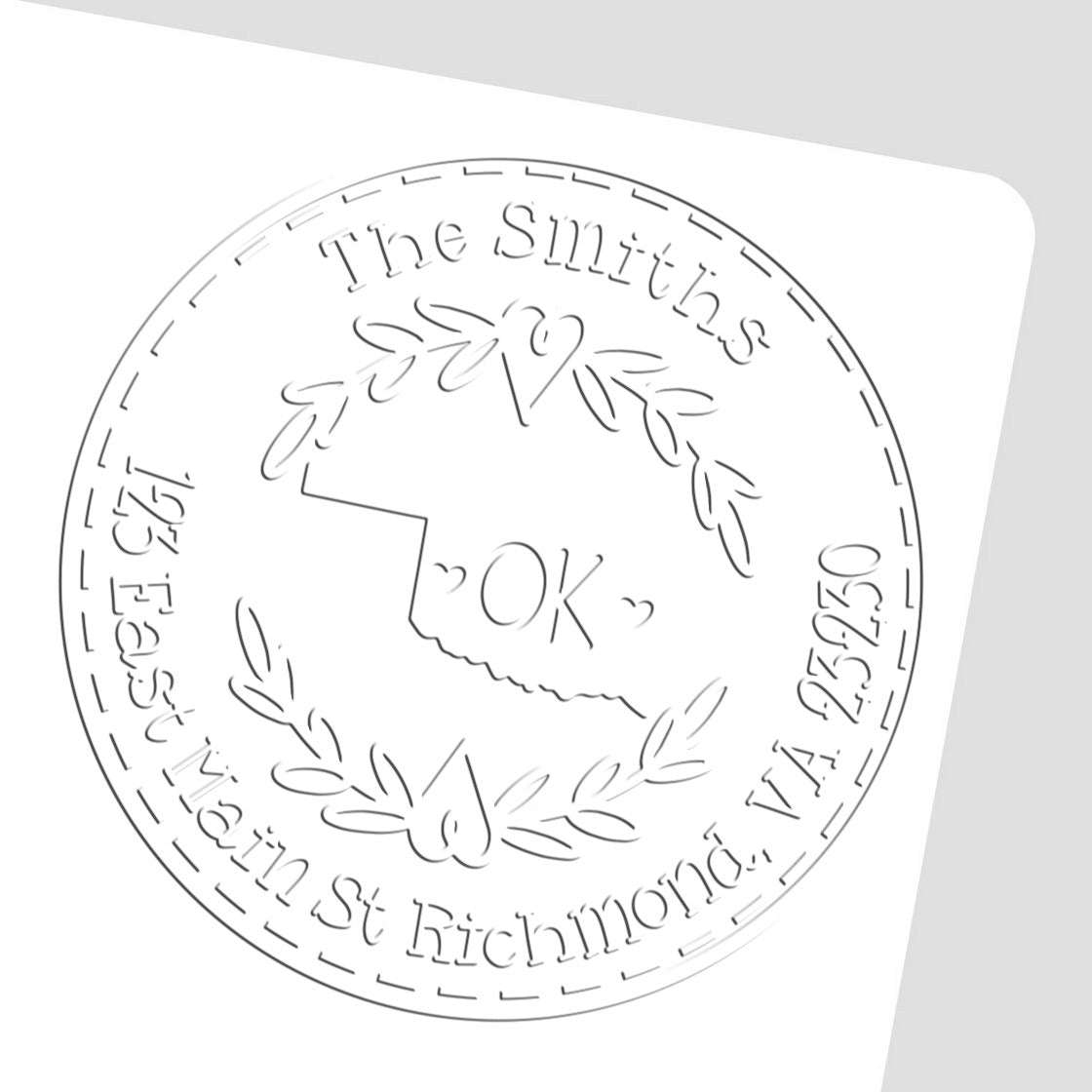 White and gray embossed custom round seal stamp with The Smiths, Oklahoma outline, laurel leaves, and OK in center.