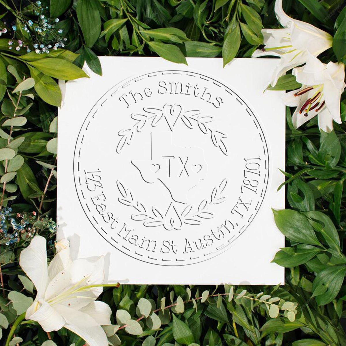 White embossed custom round stamp seal with Texas outline, The Smiths, and green leaves with white lilies.
